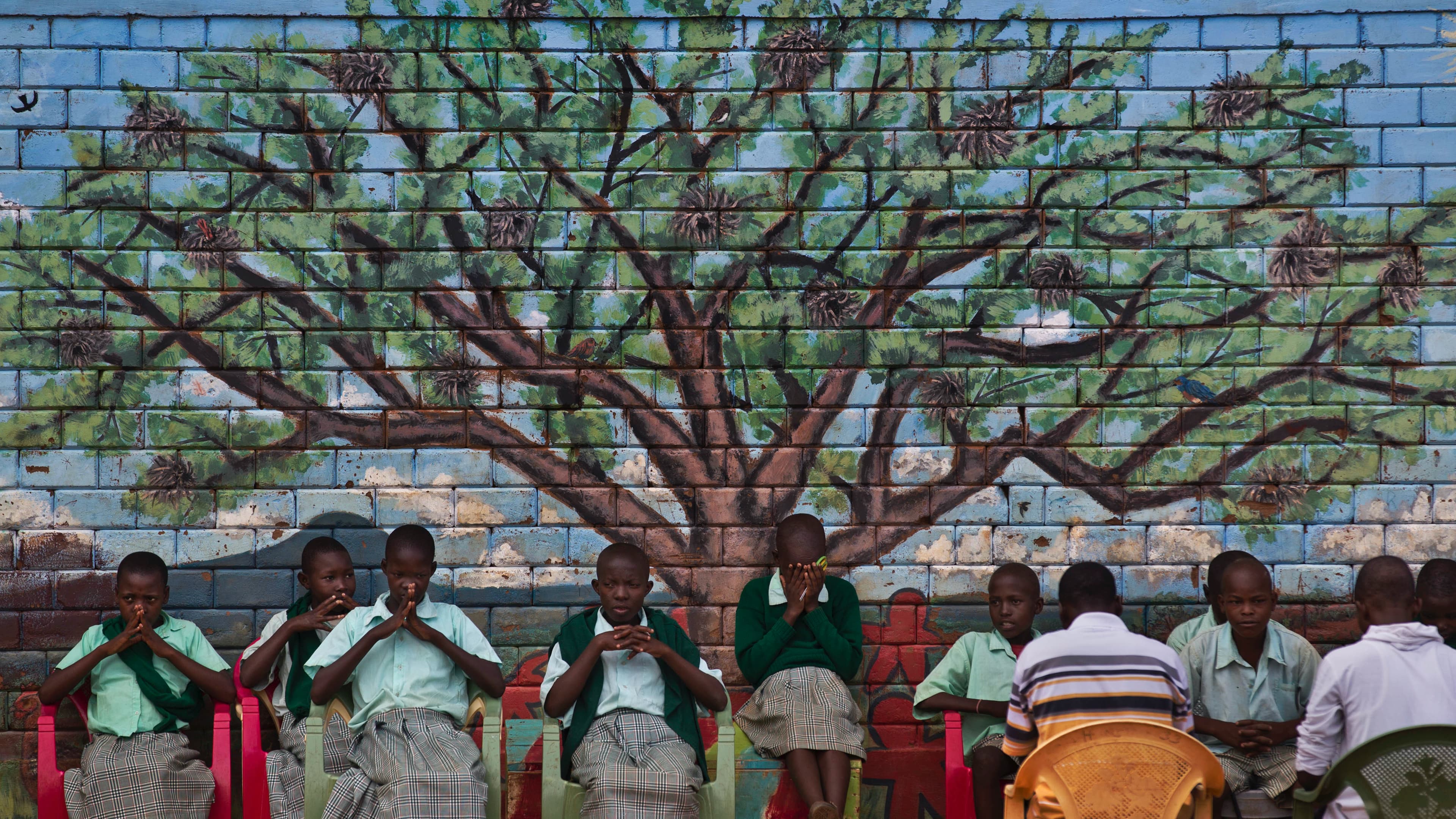 children in front of a mural