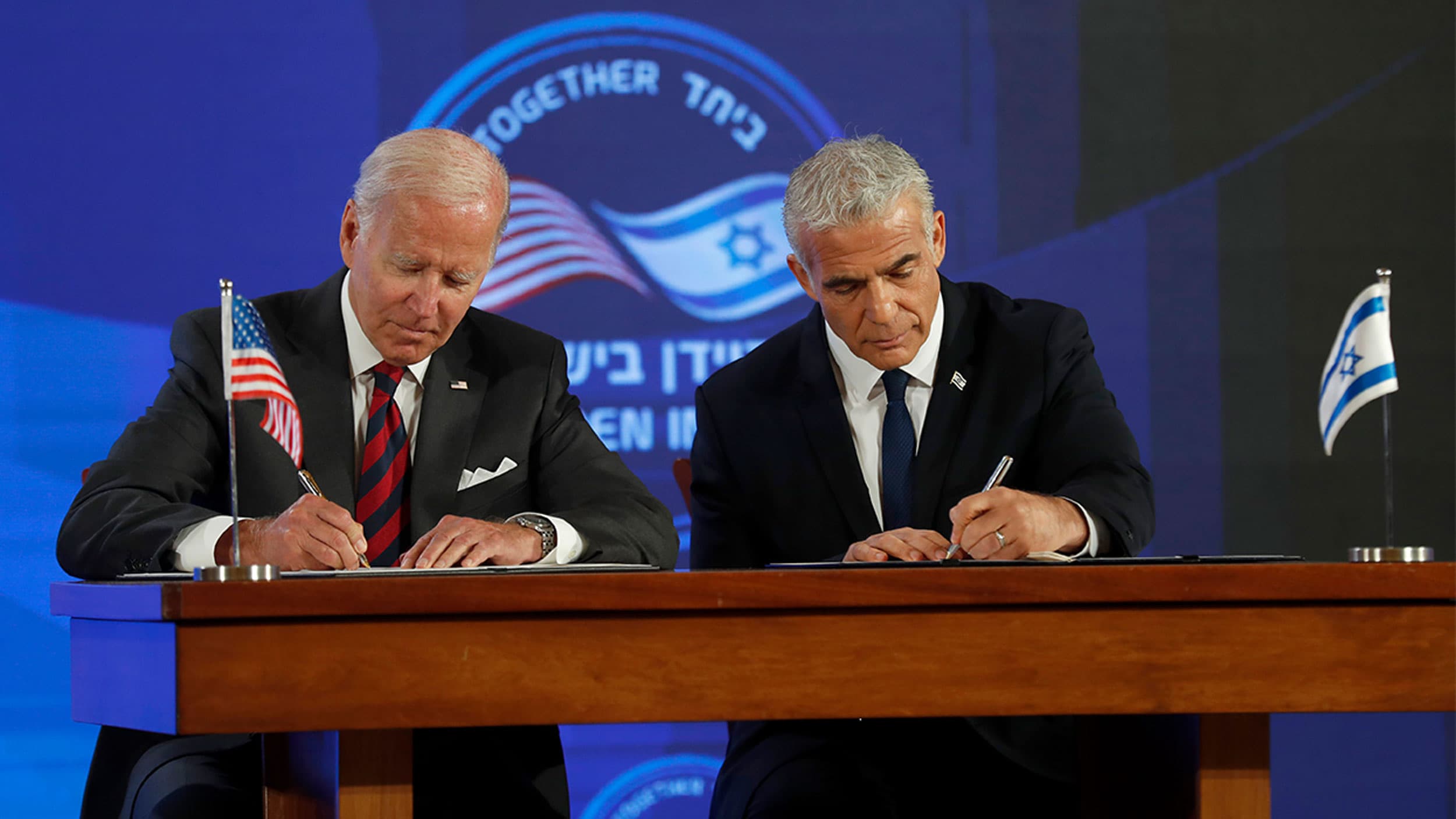 US President Joe Biden and Israel's Prime Minister Yair Lapid, sign a security pledge at the Waldorf Astoria Hotel in Jerusalem