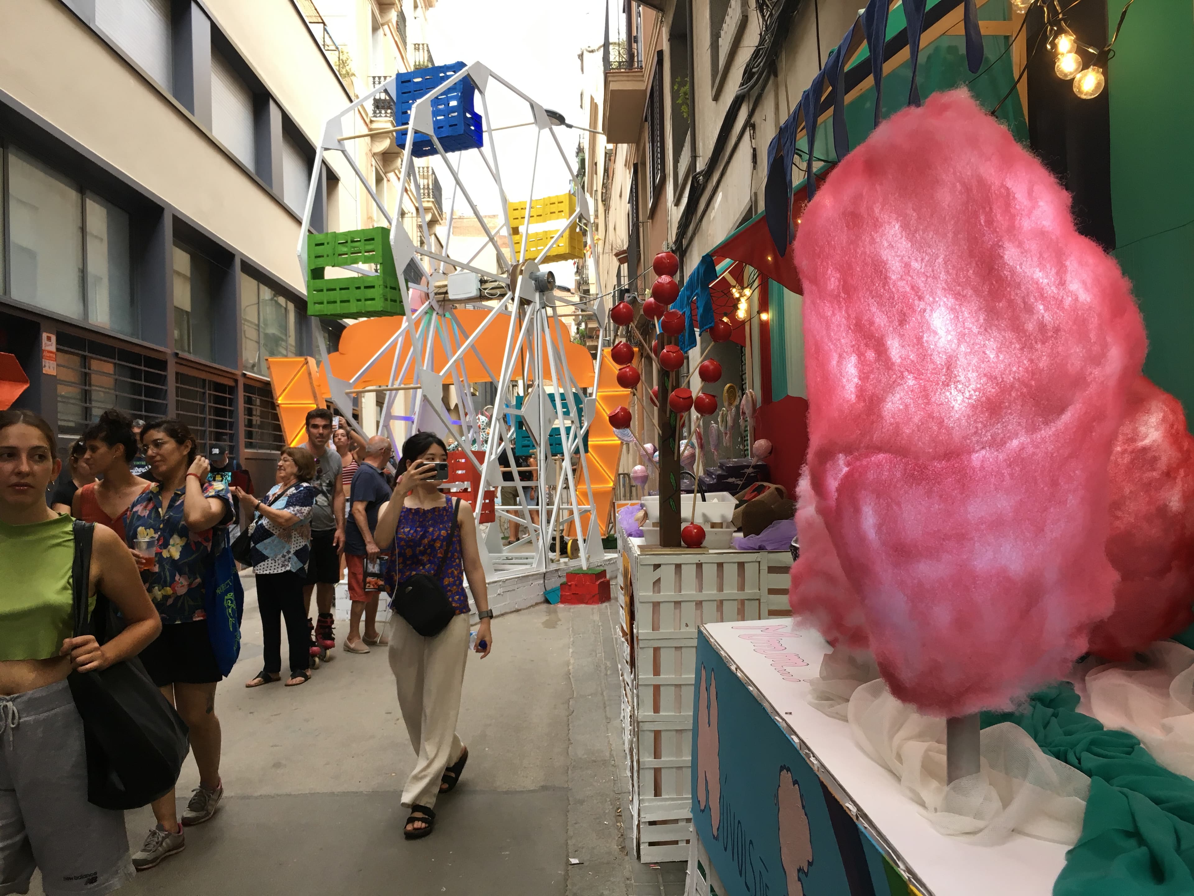 ferris wheel and other amusement park attractions on the street