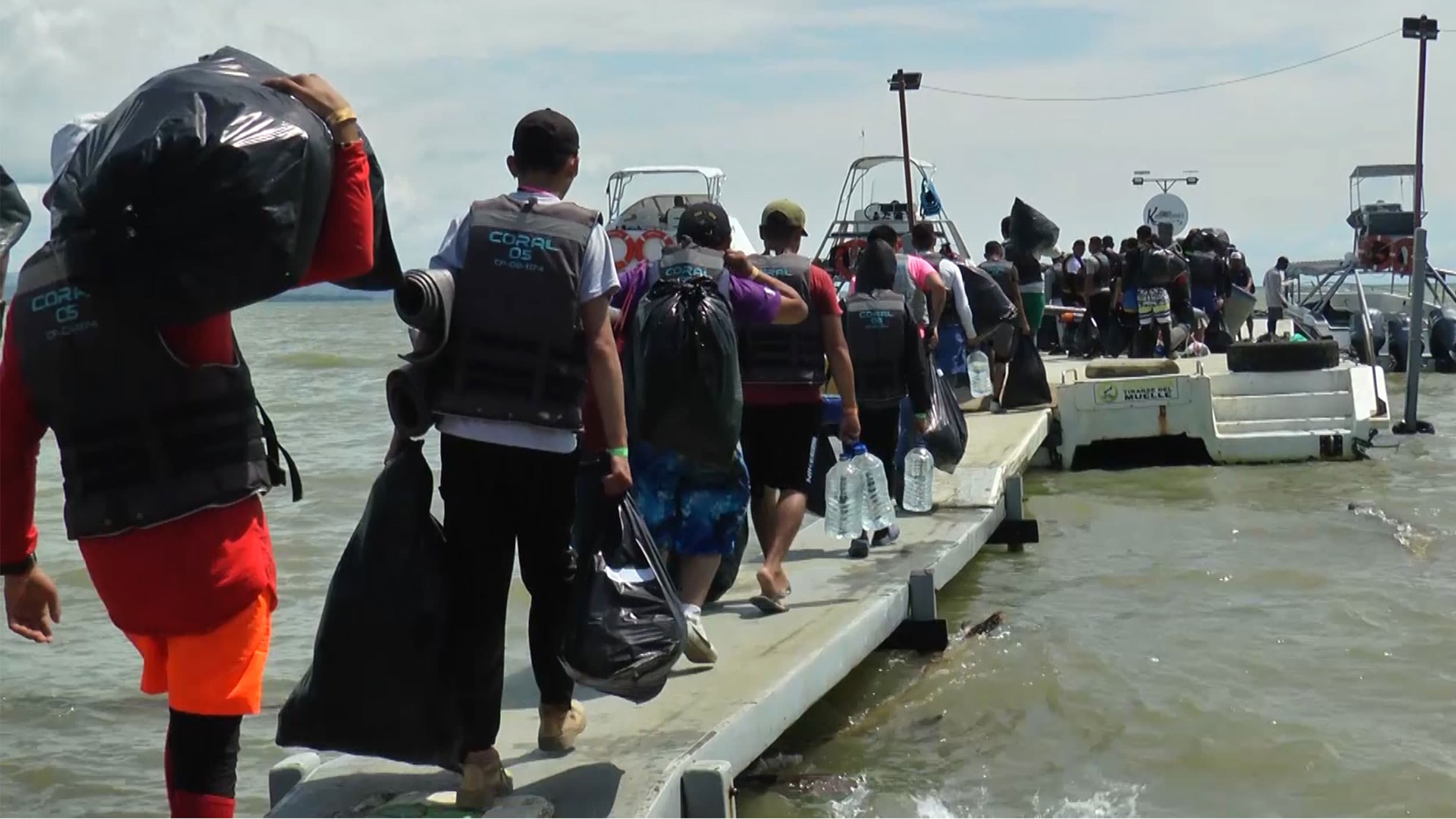 Venezuelan migrants board a boat in the Colombian city of Necocli that will take them closer to Panama, the next stop on the way to the United States
