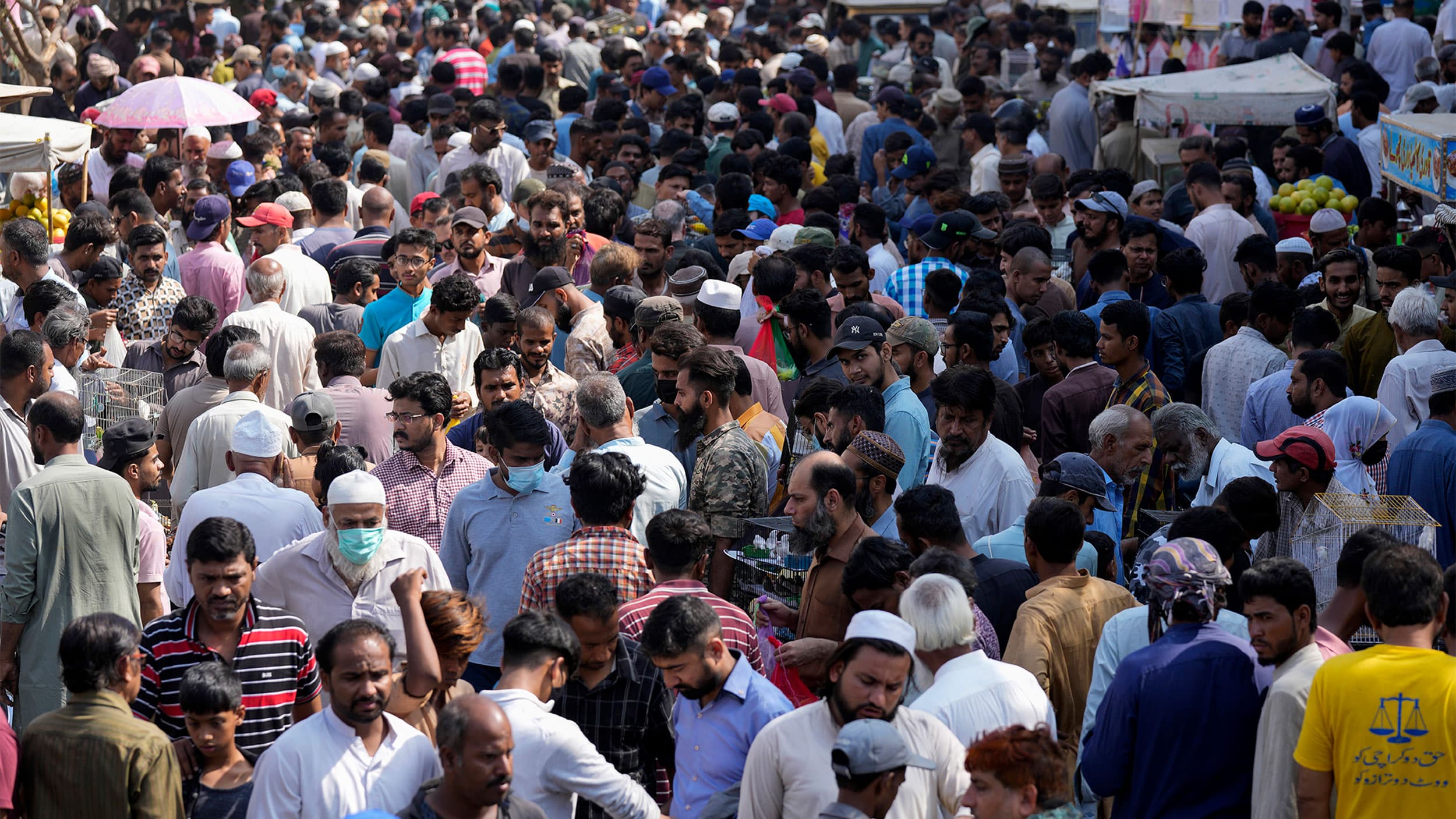 Pakistanis shops in a weekly pet market in Lahore, Pakistan, Nov. 13, 2022.