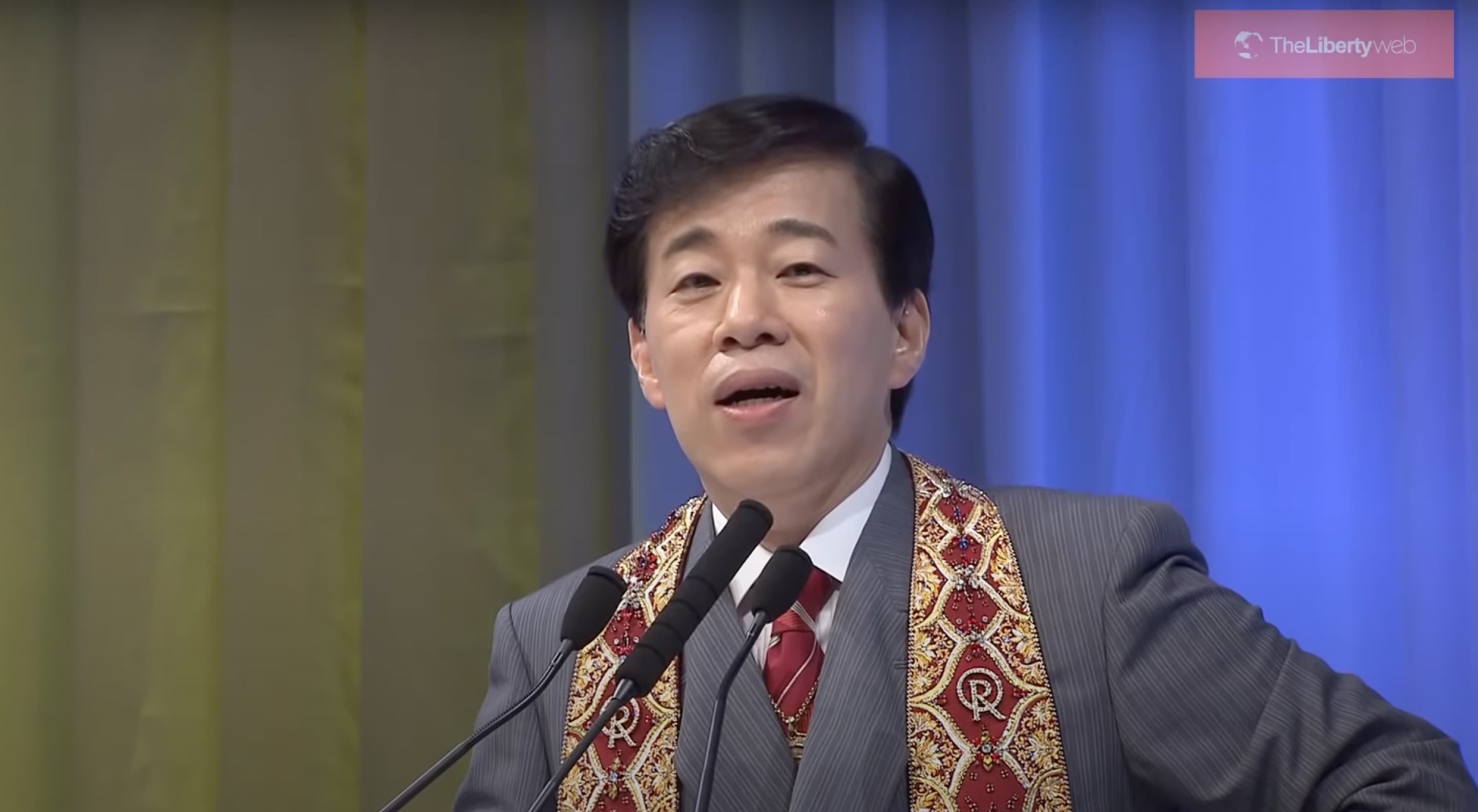 man speaking at podium