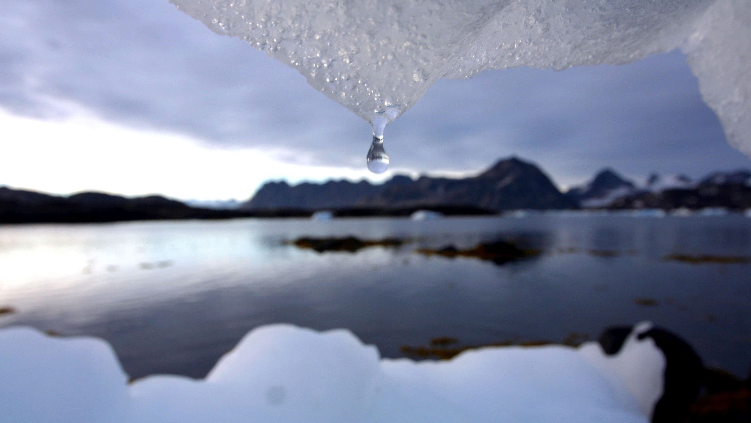 An iceberg melts in Kulusuk, Greenland near the Arctic Circle, Aug, 16, 2005. A new report finds permafrost in the Arctic is thawing faster than ever before.