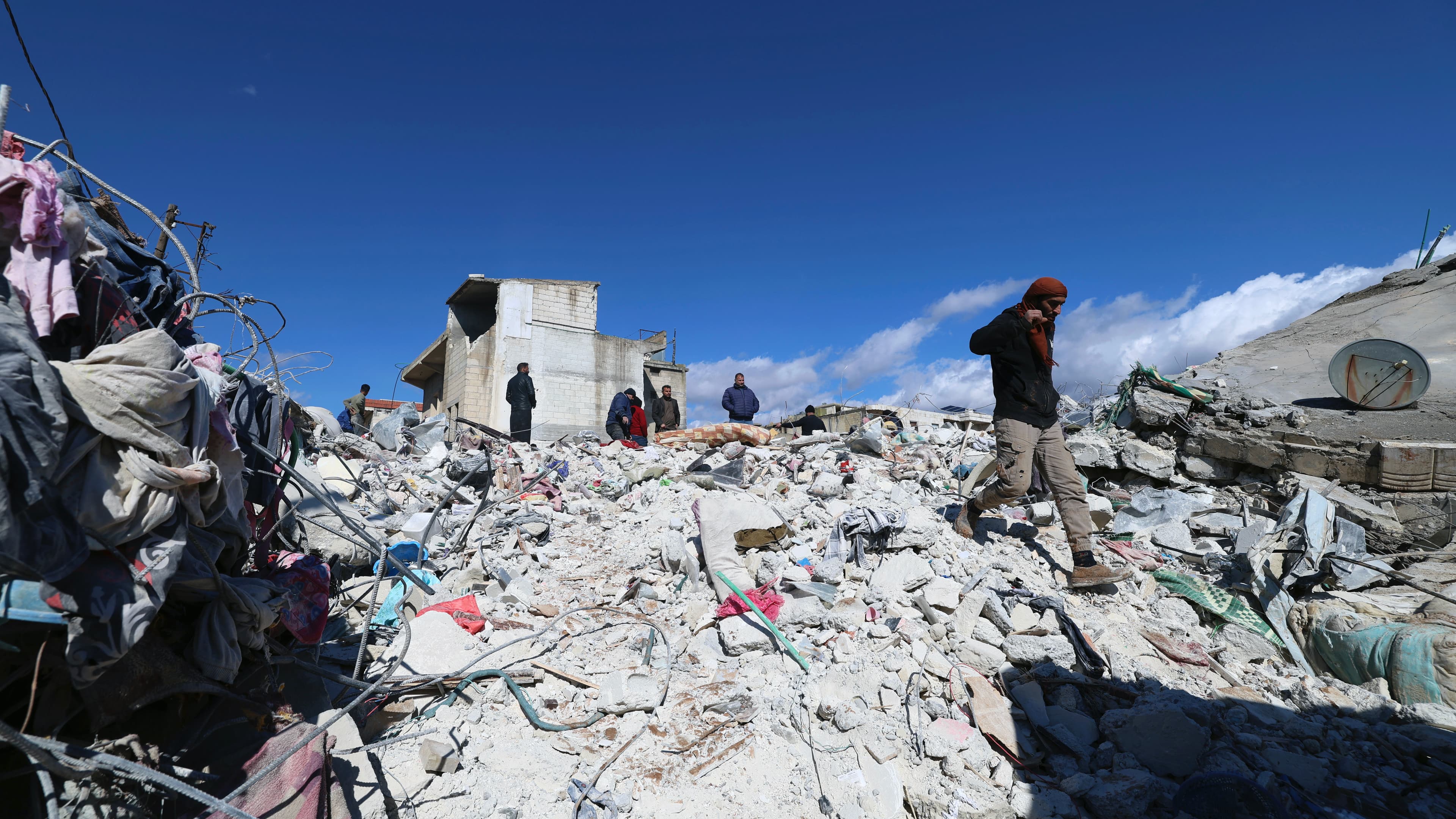 people search through rubble