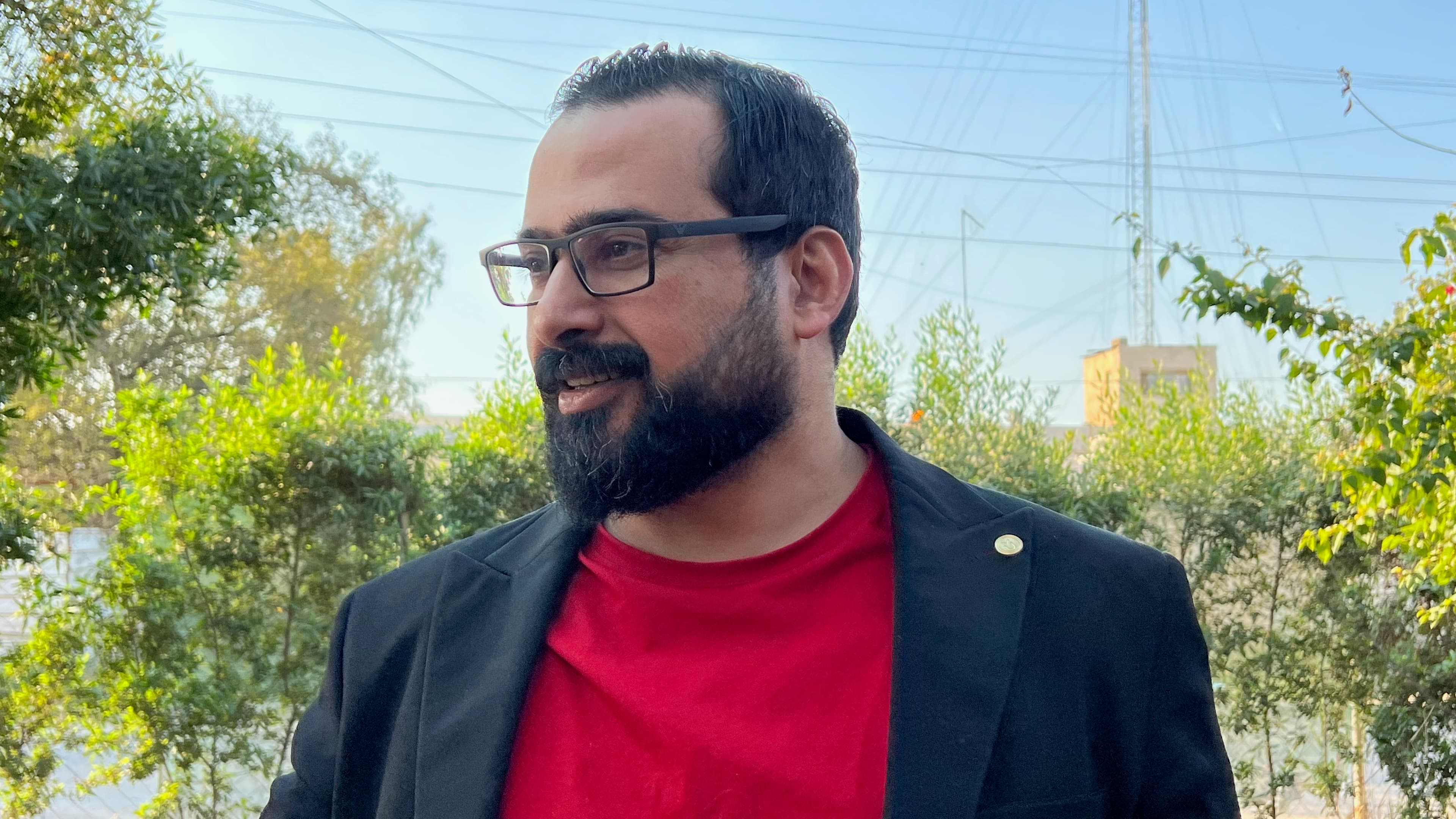 headshot of man outside