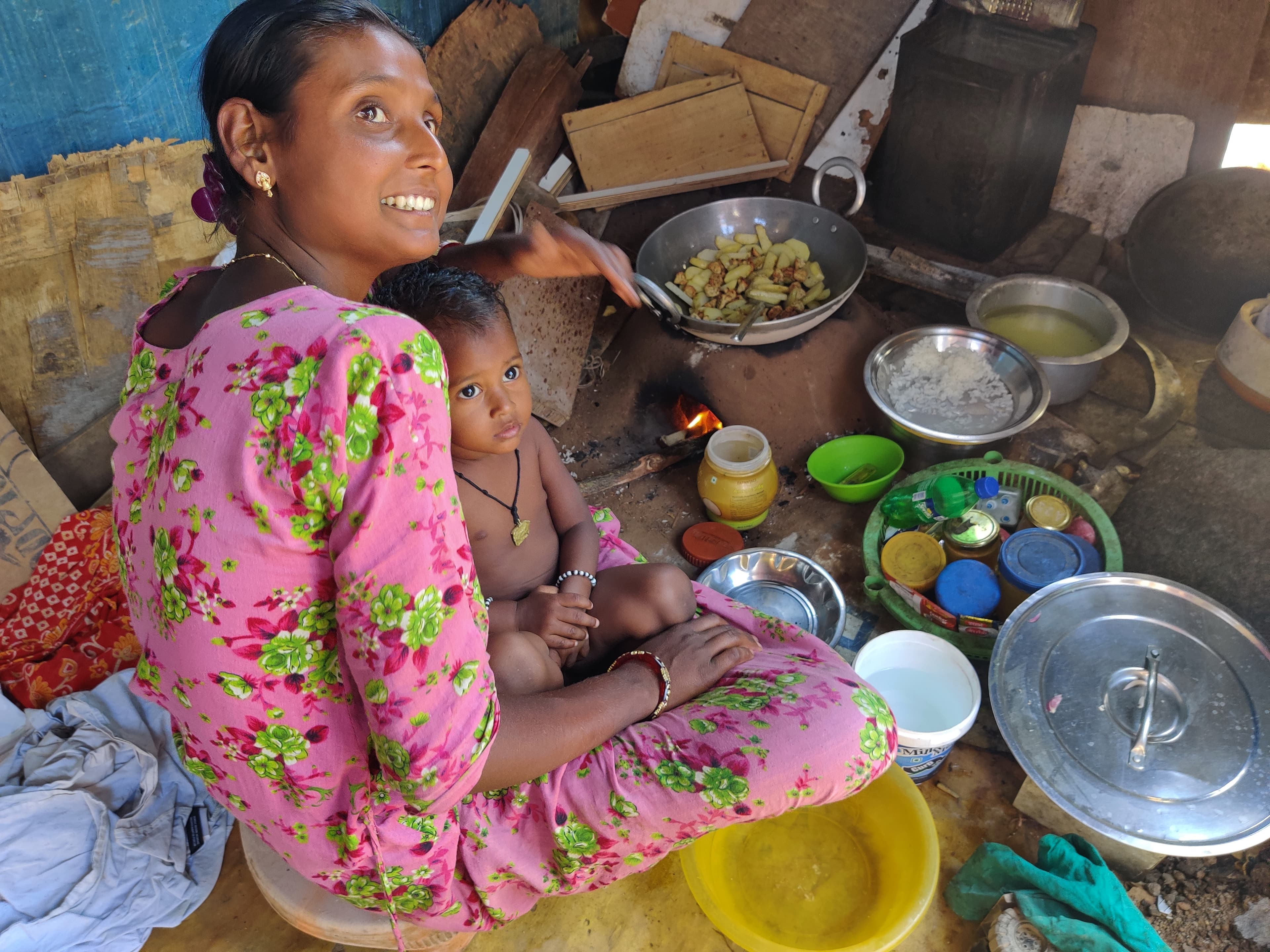 Salmina Sheikh sits with her toddler inside her home in an informal settlement in Bangalore, India.