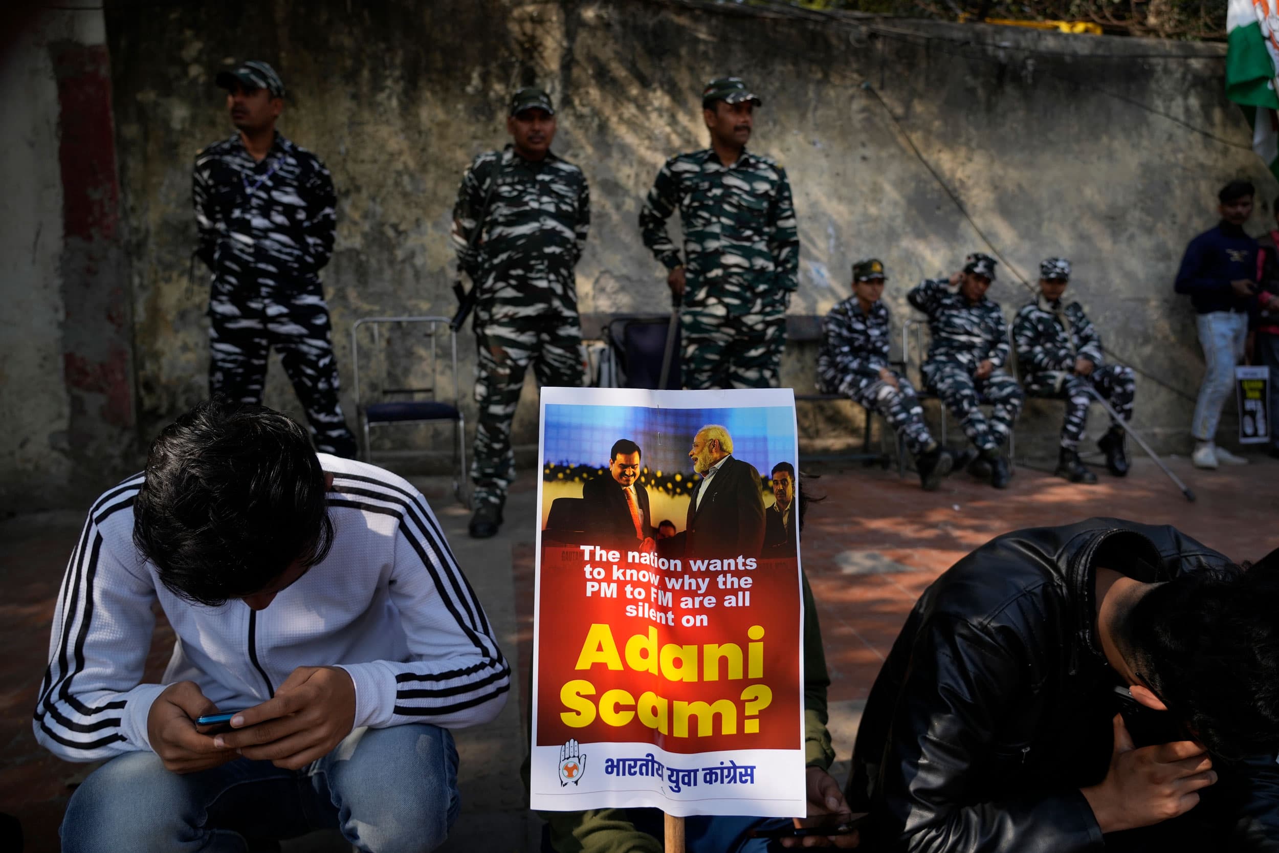 Members of opposition Congress party, demanding an investigation into allegations of fraud and stock manipulation by India's Adani Group display a placard with images of Indian businessman Gautam Adani and Indian Prime Minister Narendra Modi during a prot