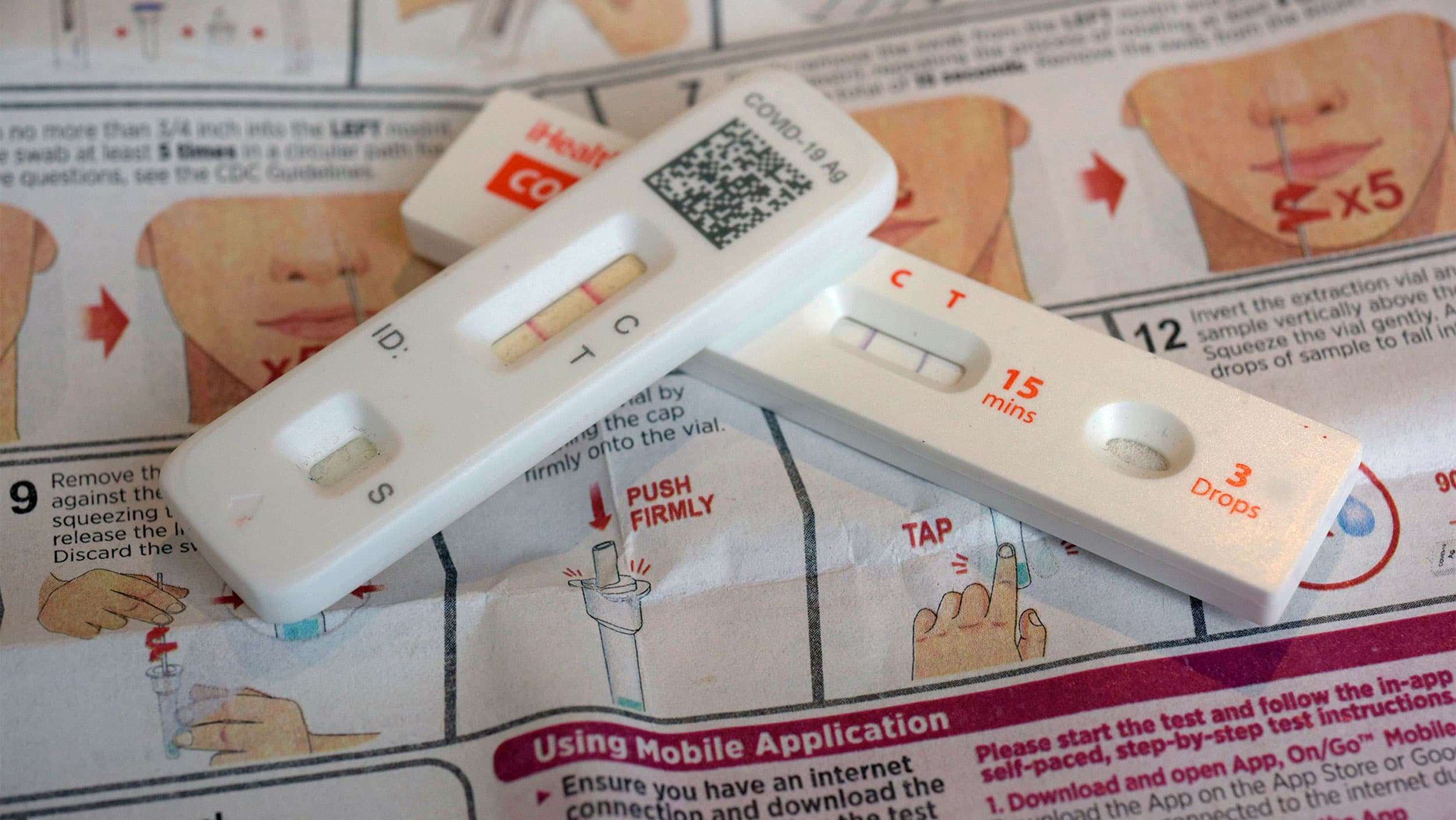 COVID-19 antigen home tests indicating a positive result are photographed in New York, April 5, 2023.