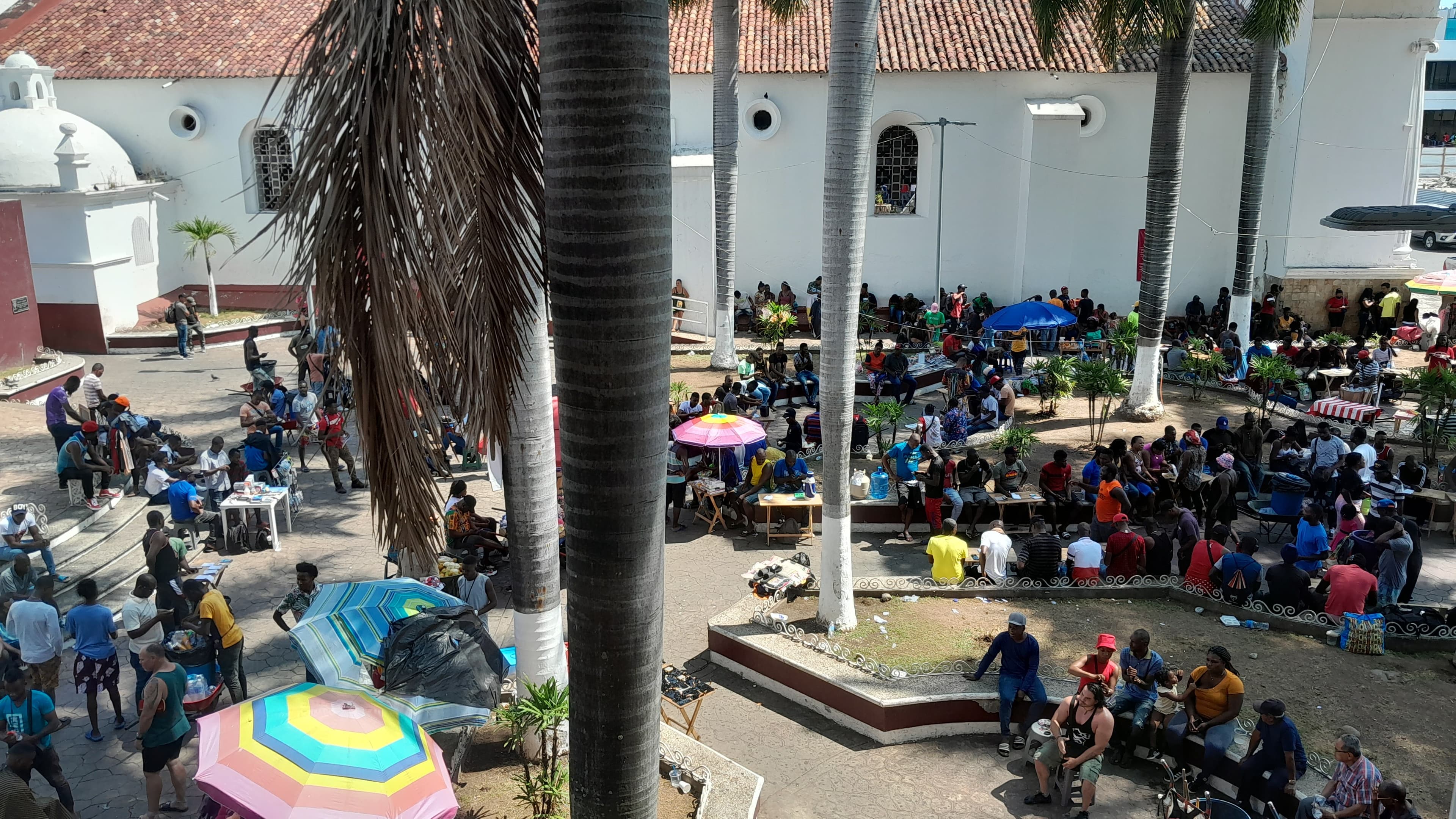 Different groups of people congregating in a downtown public square