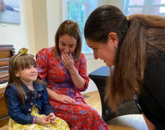 Karolina looks up at Ambassador Oksana Markarova during her final trip to Washington DC, as Daria Khatina looks on.