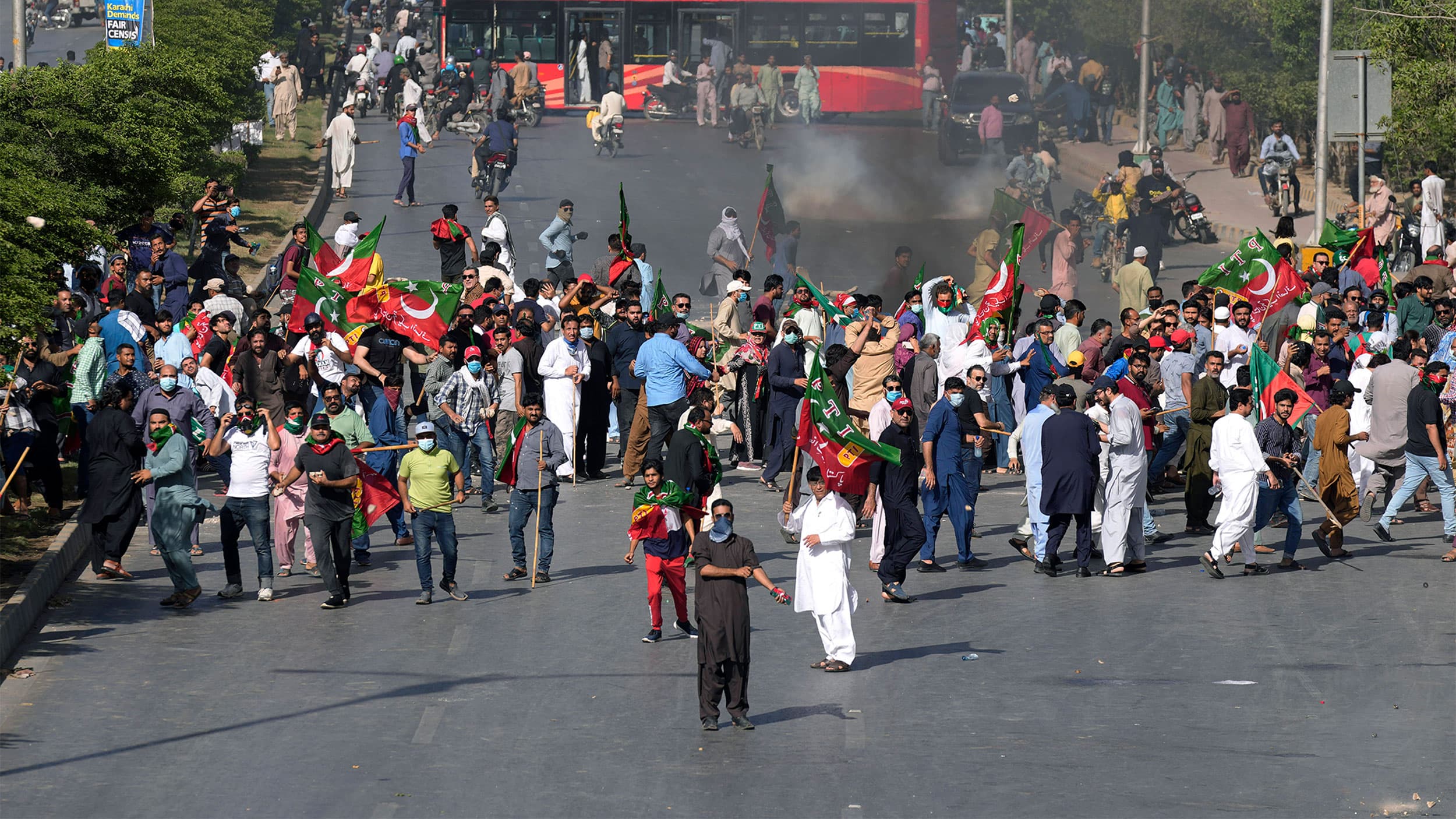 Supporters of Pakistan's former Prime Minister Imran Khan throw stones toward police during a protest against the arrest of Khan, in Karachi, Pakistan, May 9, 2023.