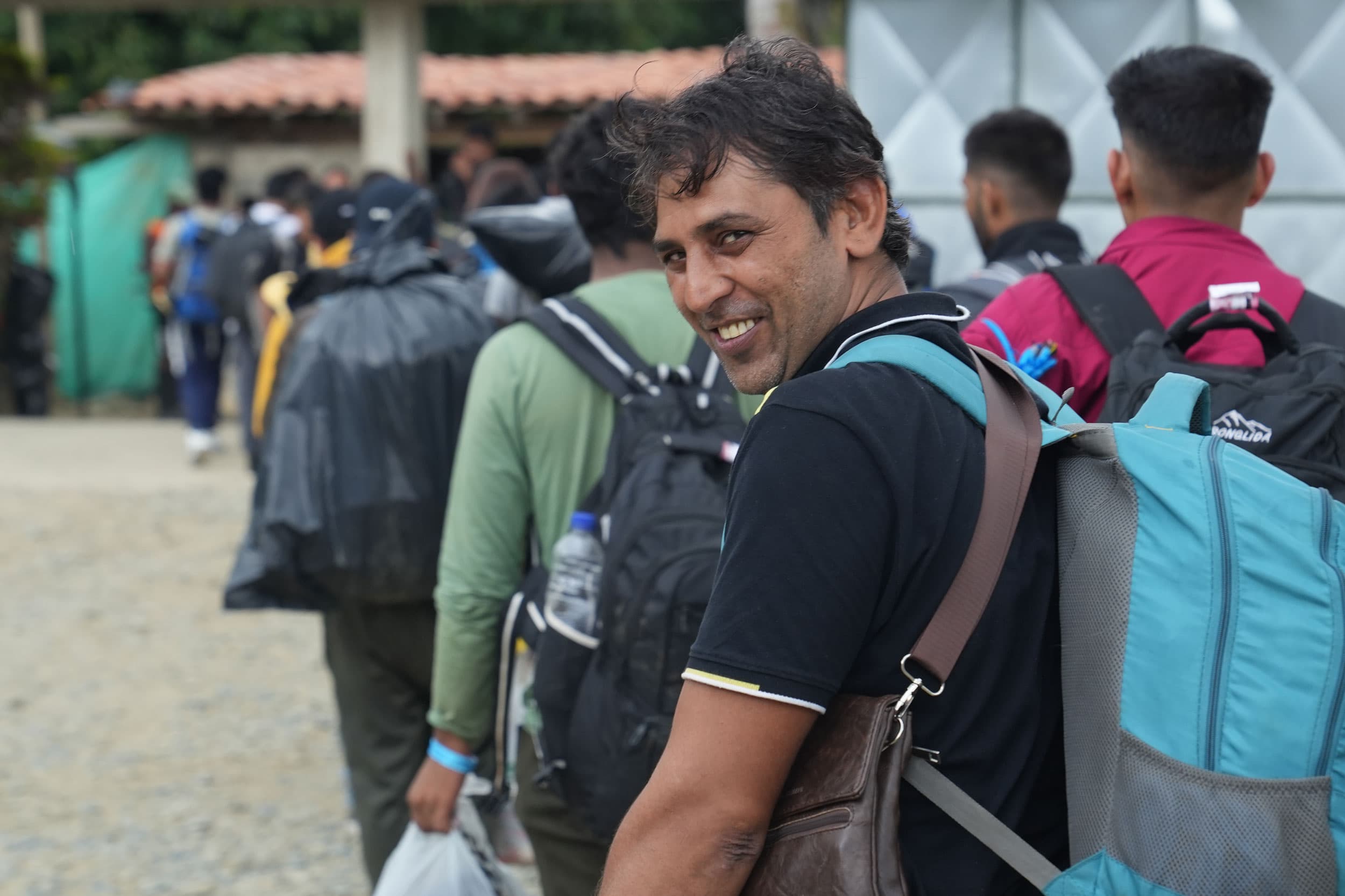 Migrants who pay for guides are quickly led out of the shelter, and start the trek across the rainforest.