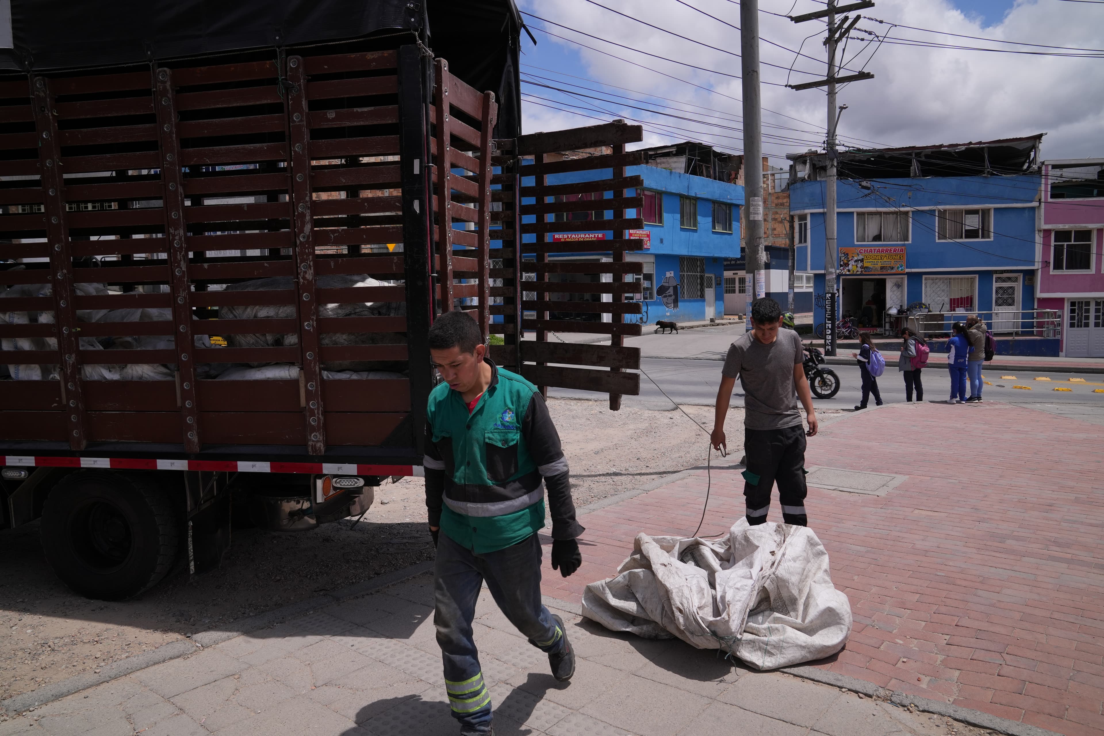 two people with trash