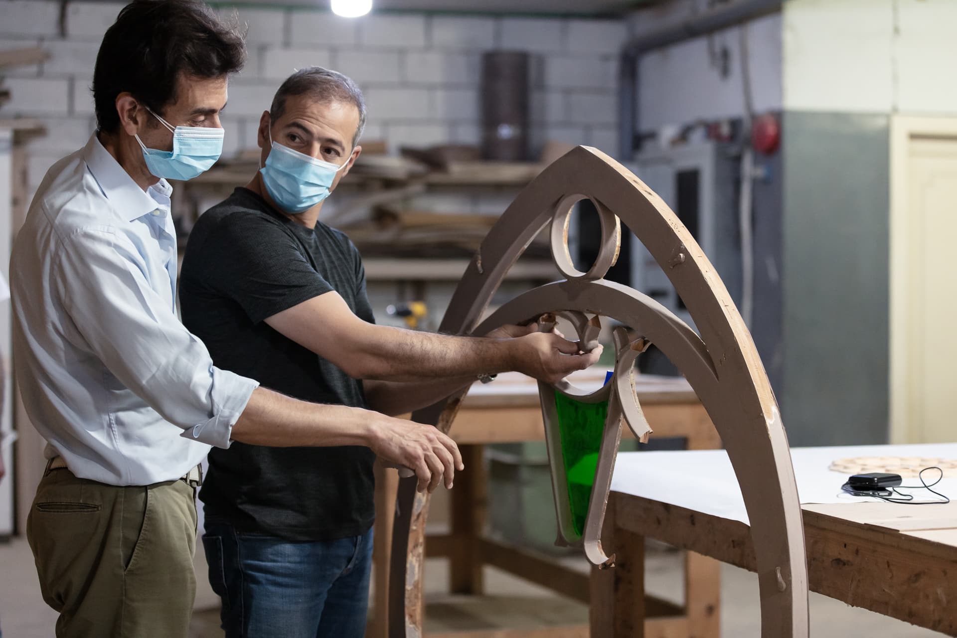 men handling window frame