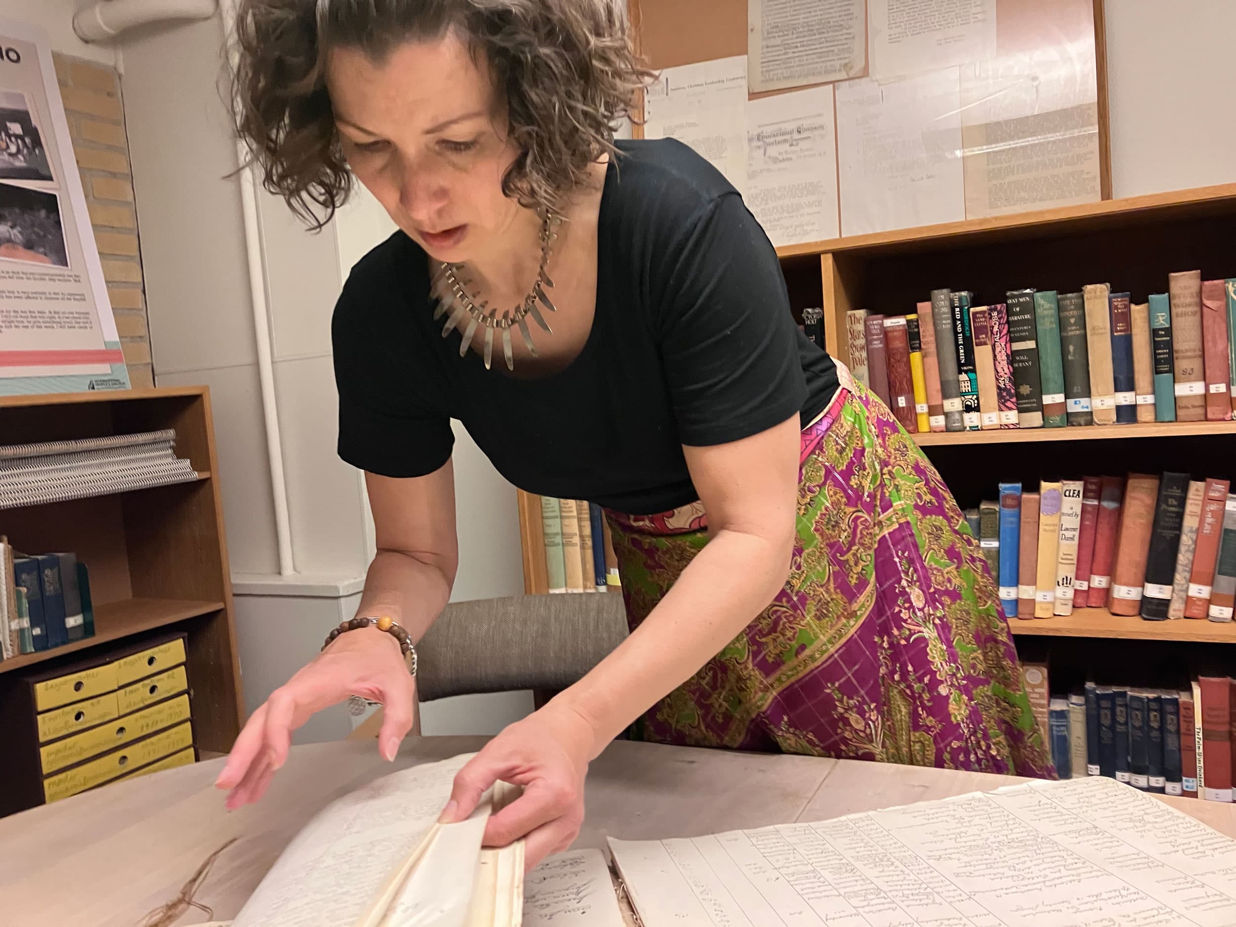 Julie Shackleford, an American anthropologist and teacher at the IPC, shows where activist Myles Horton signed the IPC guestbook in 1931.
