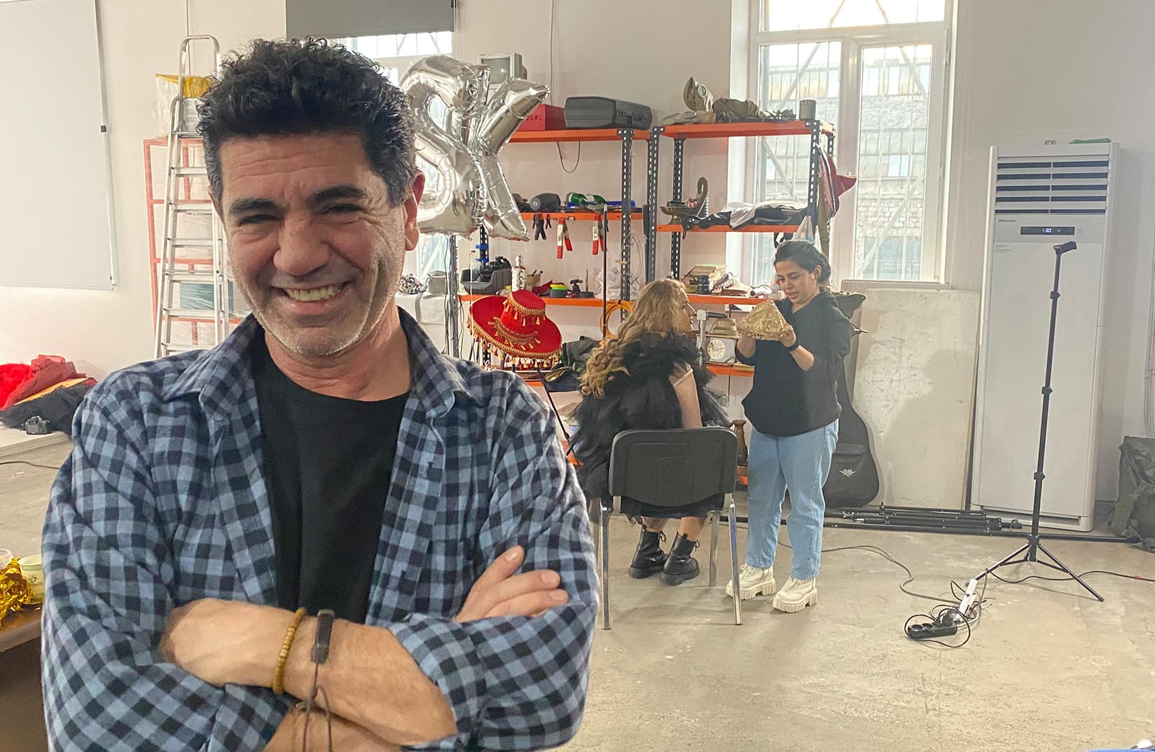 photo of a man smiling and crossing his arms