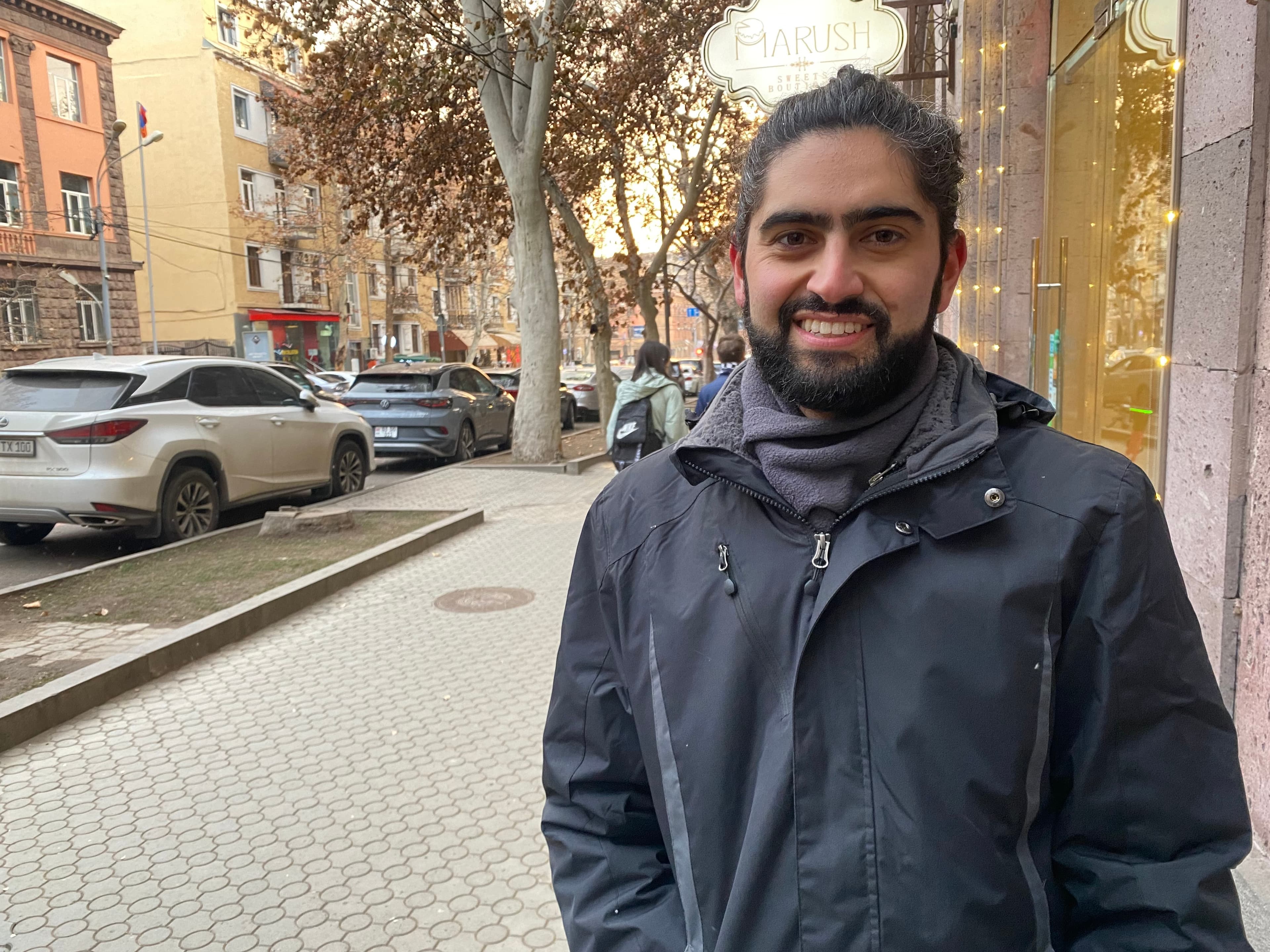 man wearing a jacket and smiling