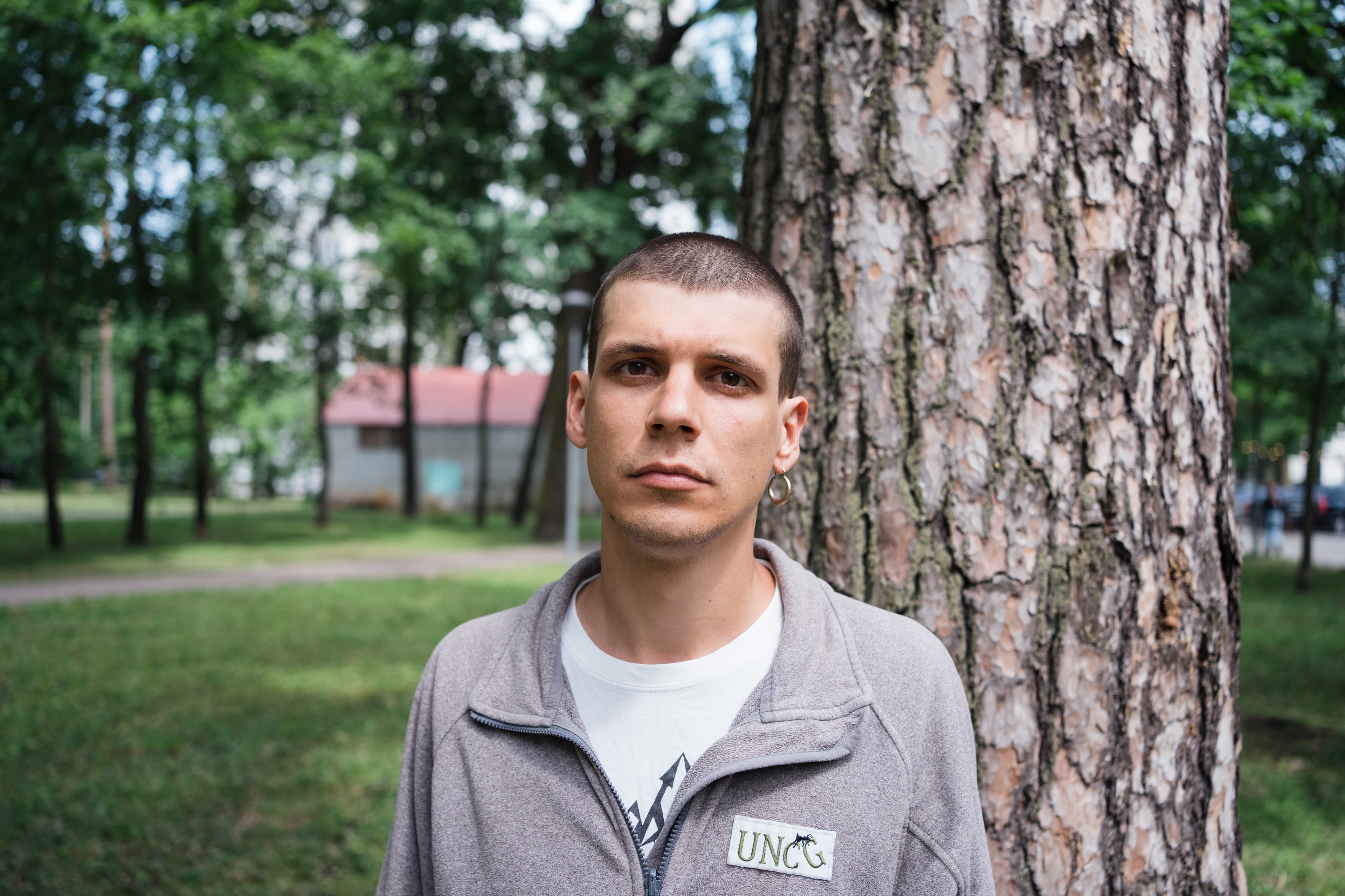 man standing in front of a tree