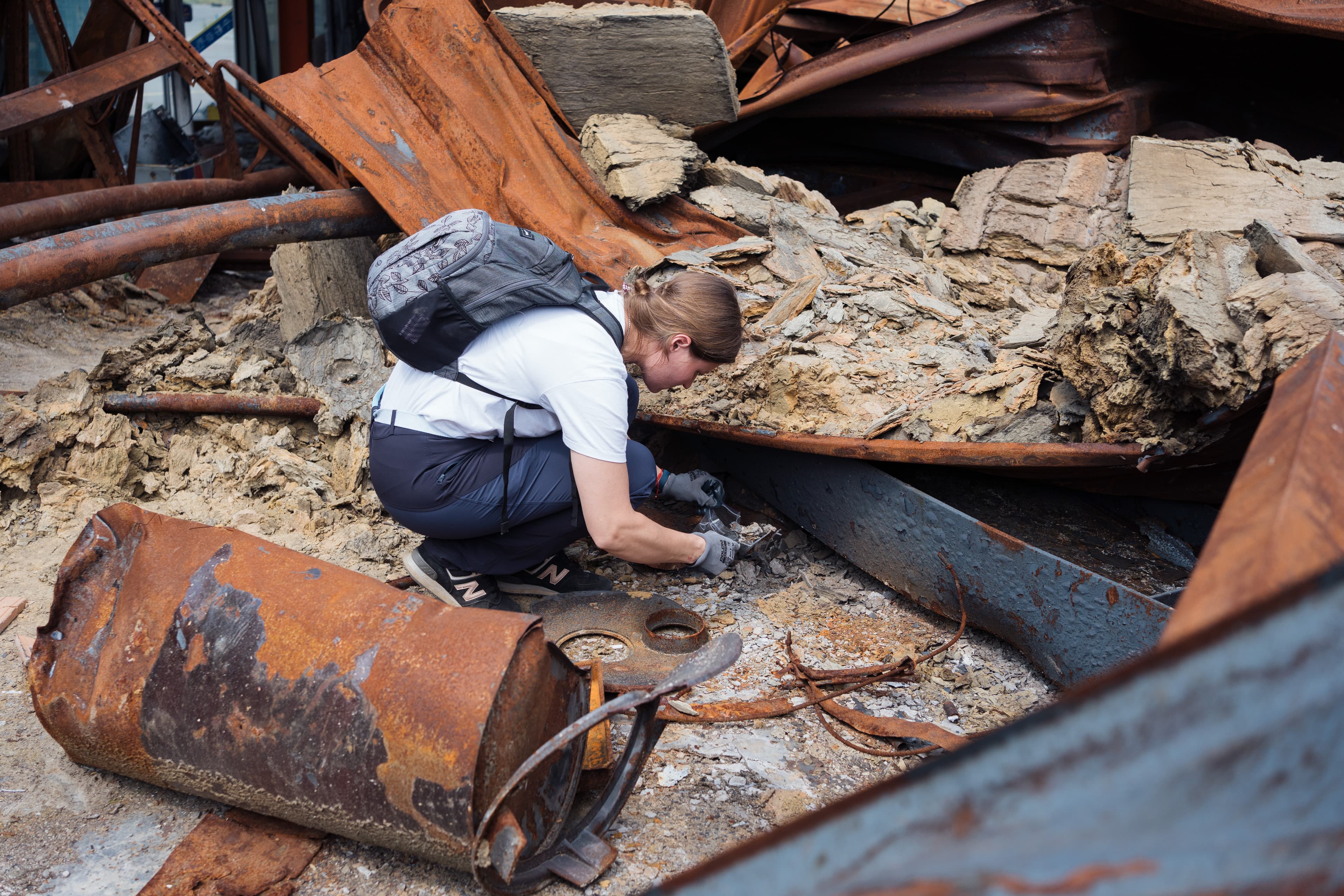 Woman digging through rubble