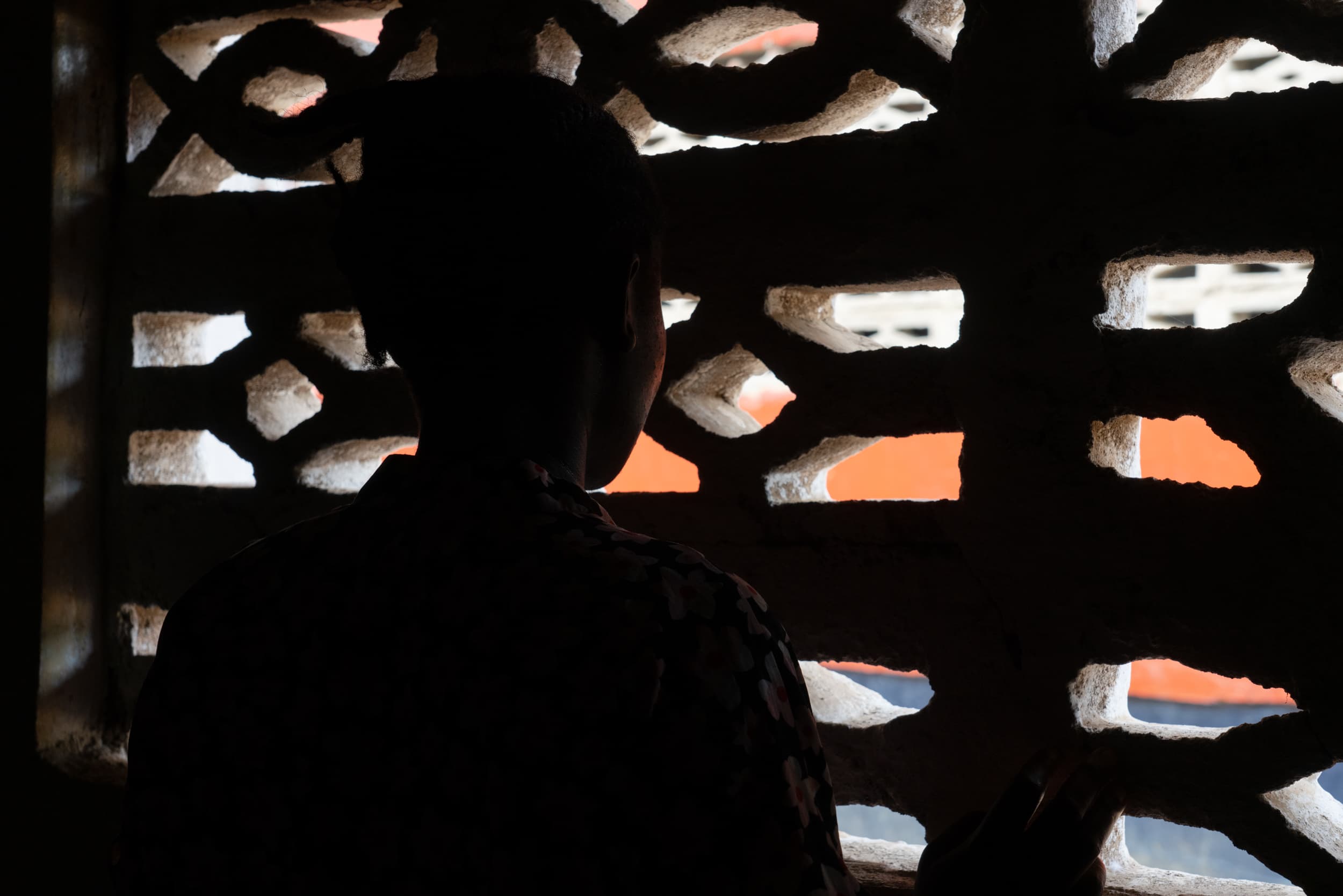 woman looking out window