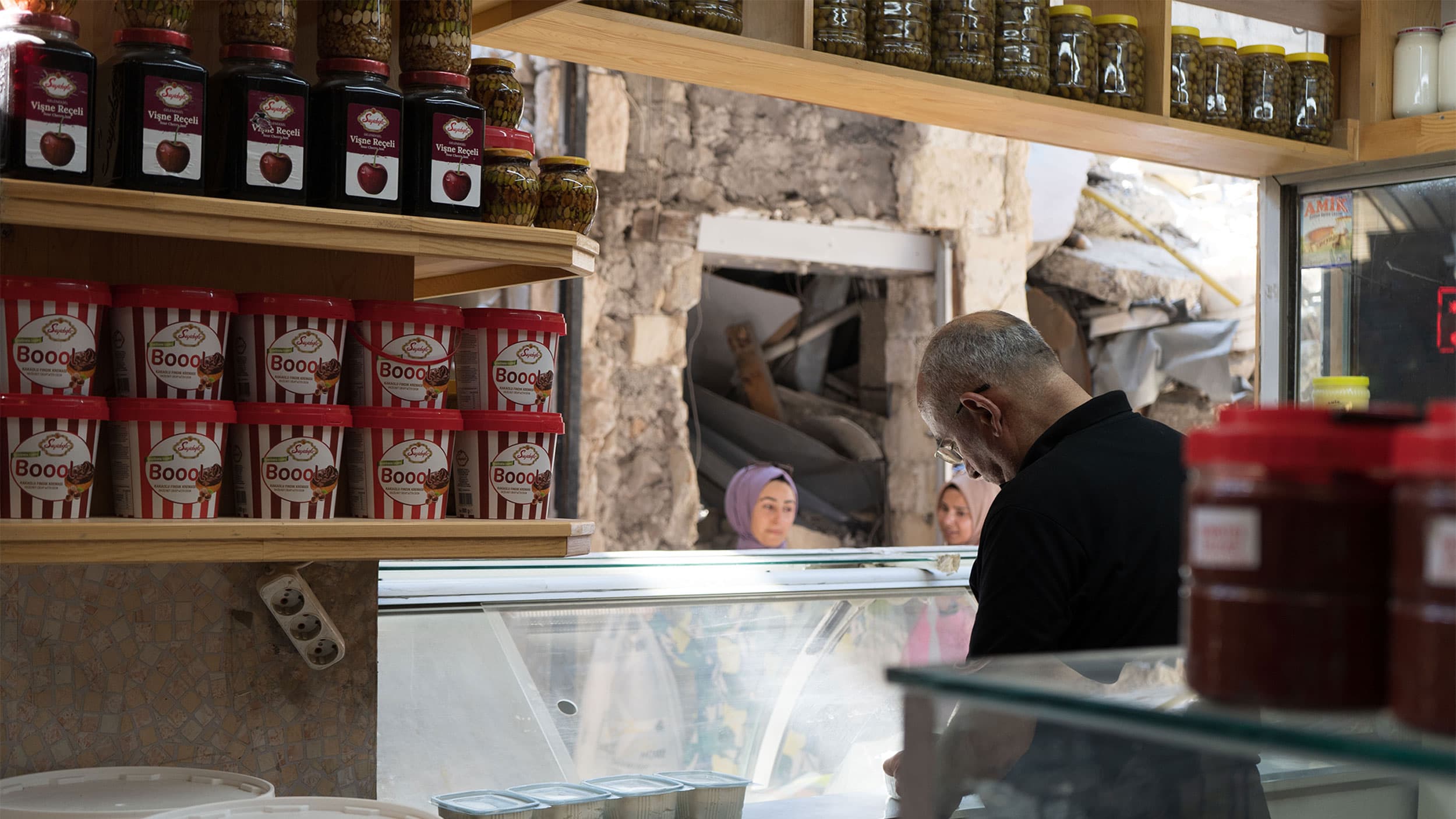 Antakya’s Uzun Çarşı, a historic covered bazaar, was partially destroyed during the Feb. 6 earthquakes. Workers have cleared much of the debris from walkways and shopkeepers have reopened, sometimes directly across from piles of rubble.