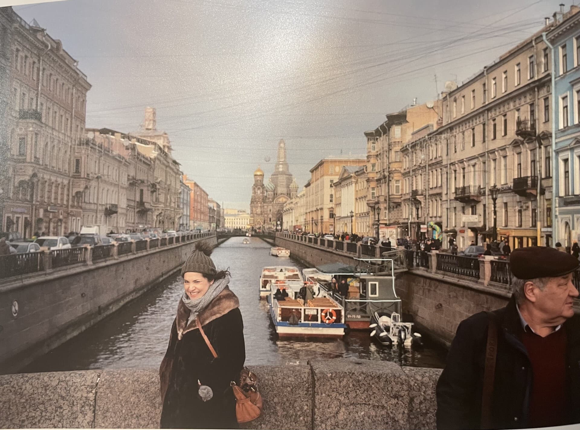 a pregnant woman in the forefront of a bridge and waterway