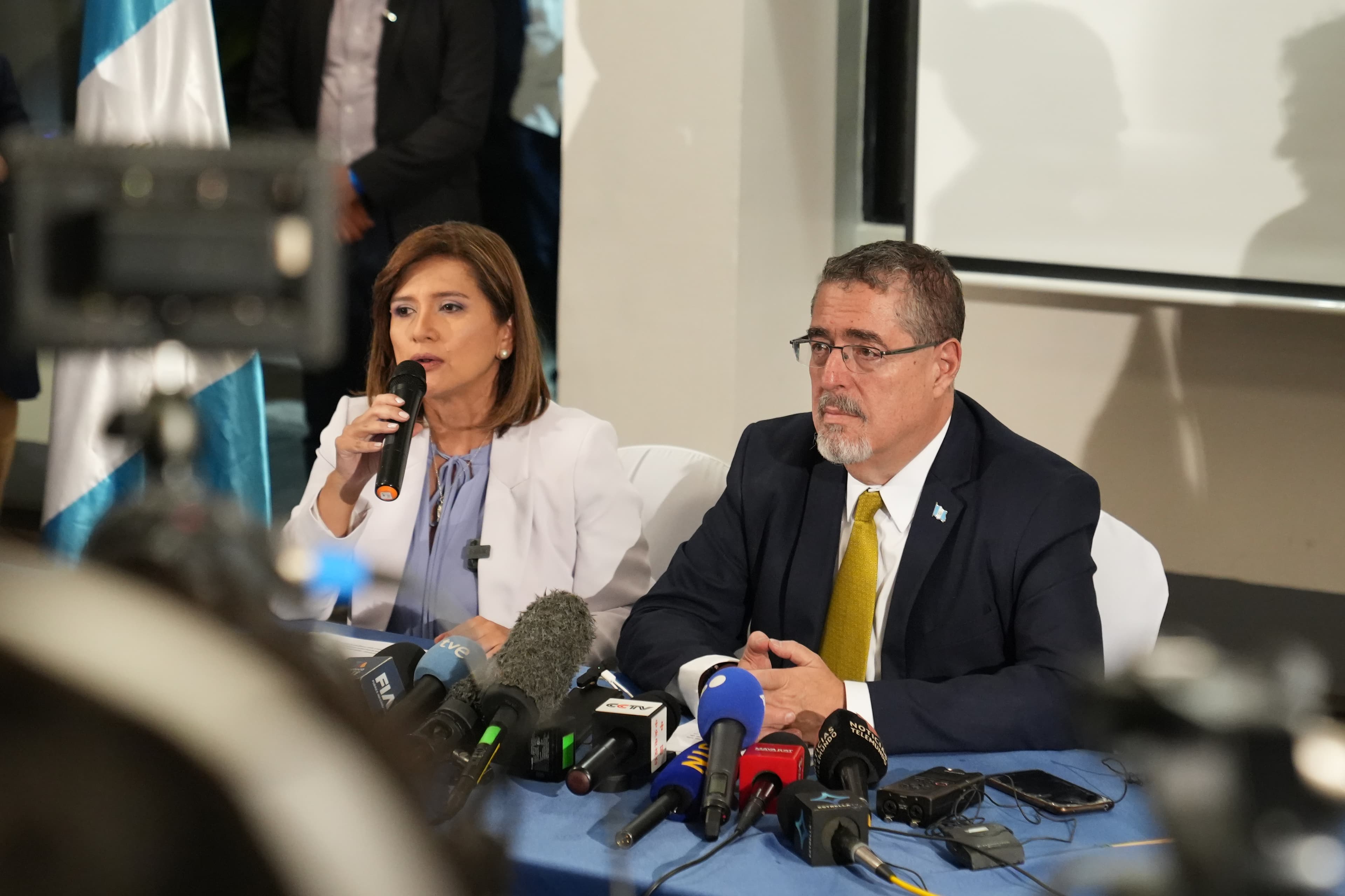 two people speaking from a table
