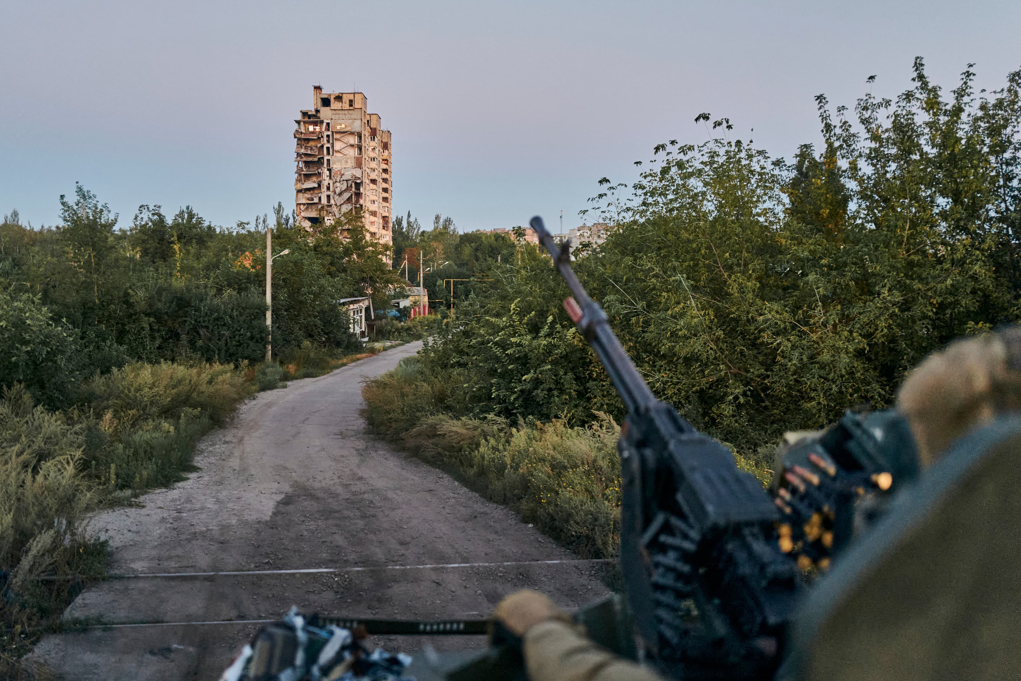 Point of view of a soldier on a field with a building in view