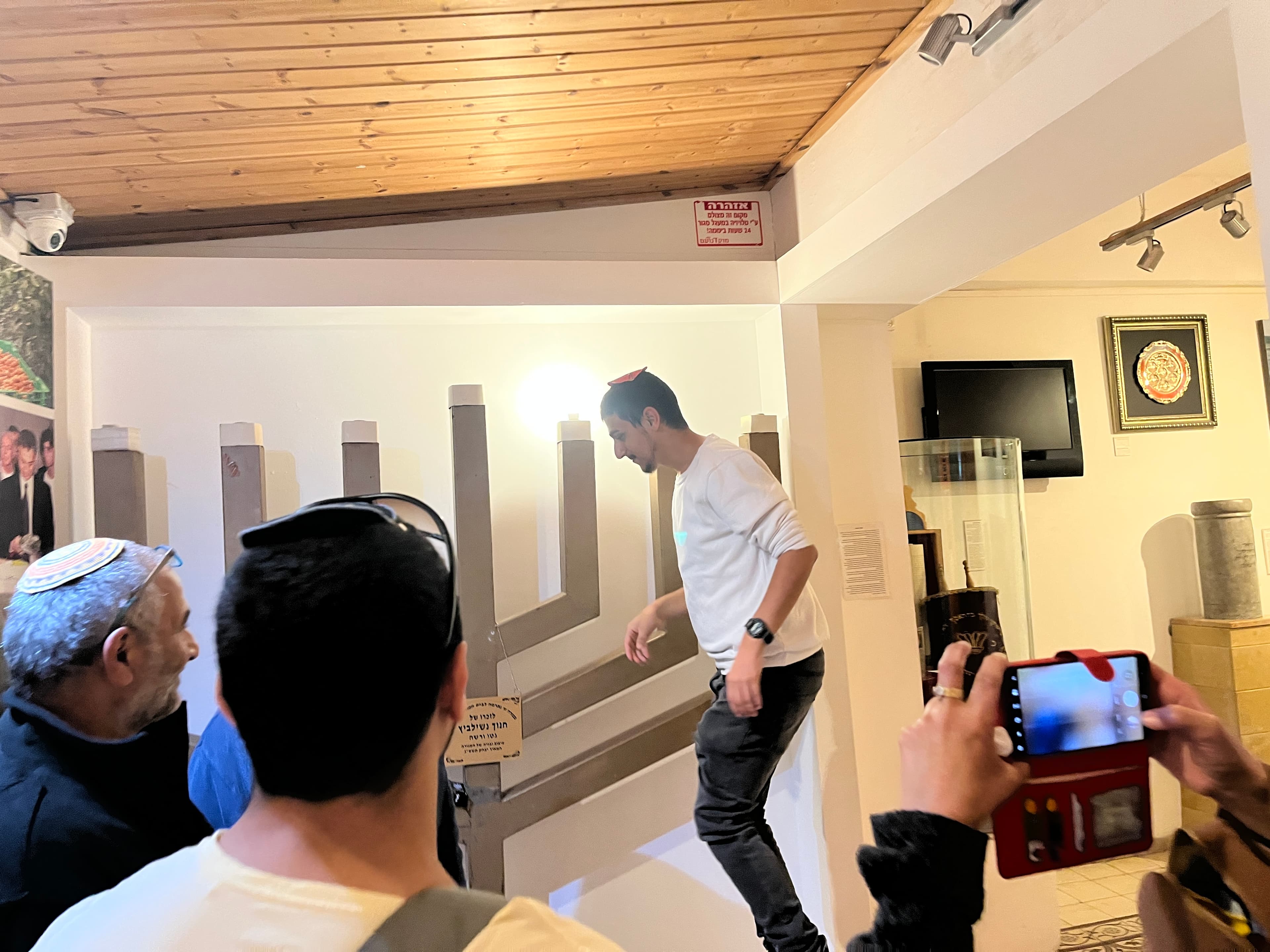 People stand in front of a giant menorah