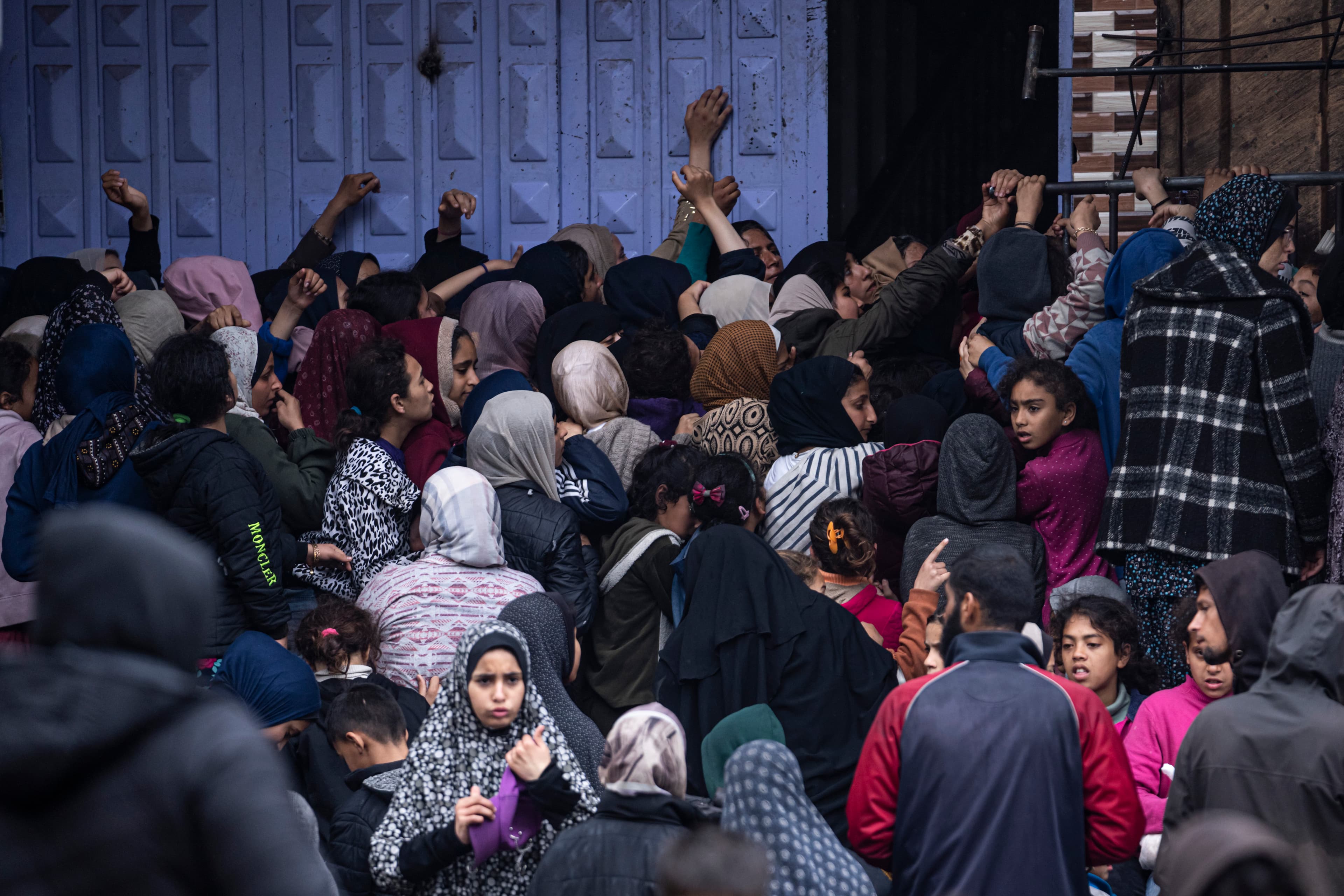 Palestinian crowds struggle to buy bread from a bakery in Rafah, Gaza Strip, Feb. 18, 2024.