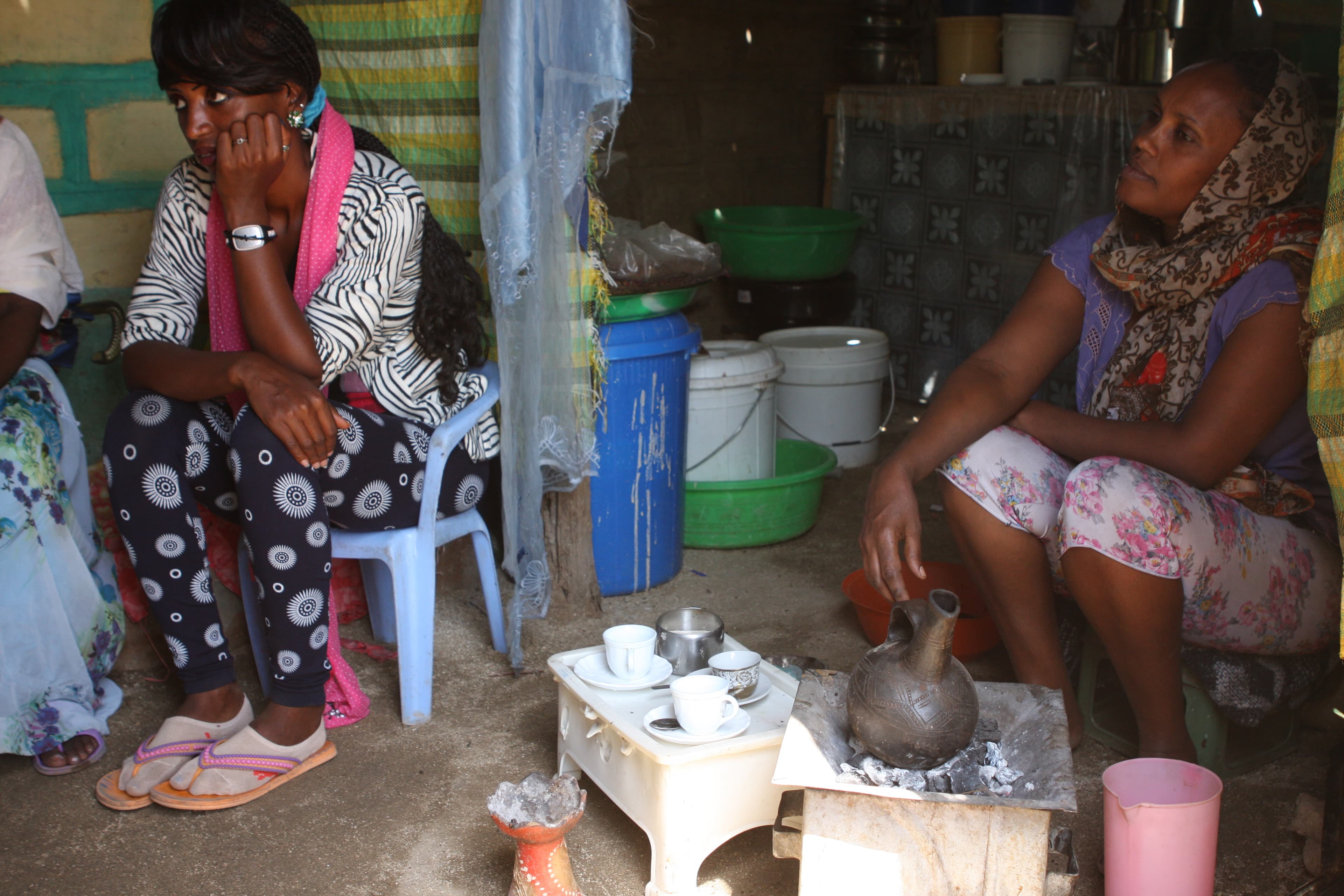 Ariam (R), 32, makes coffee in her home. She came to Hitsats camp four years ago with her two children after spending four years in a Sudanese refugee camp.