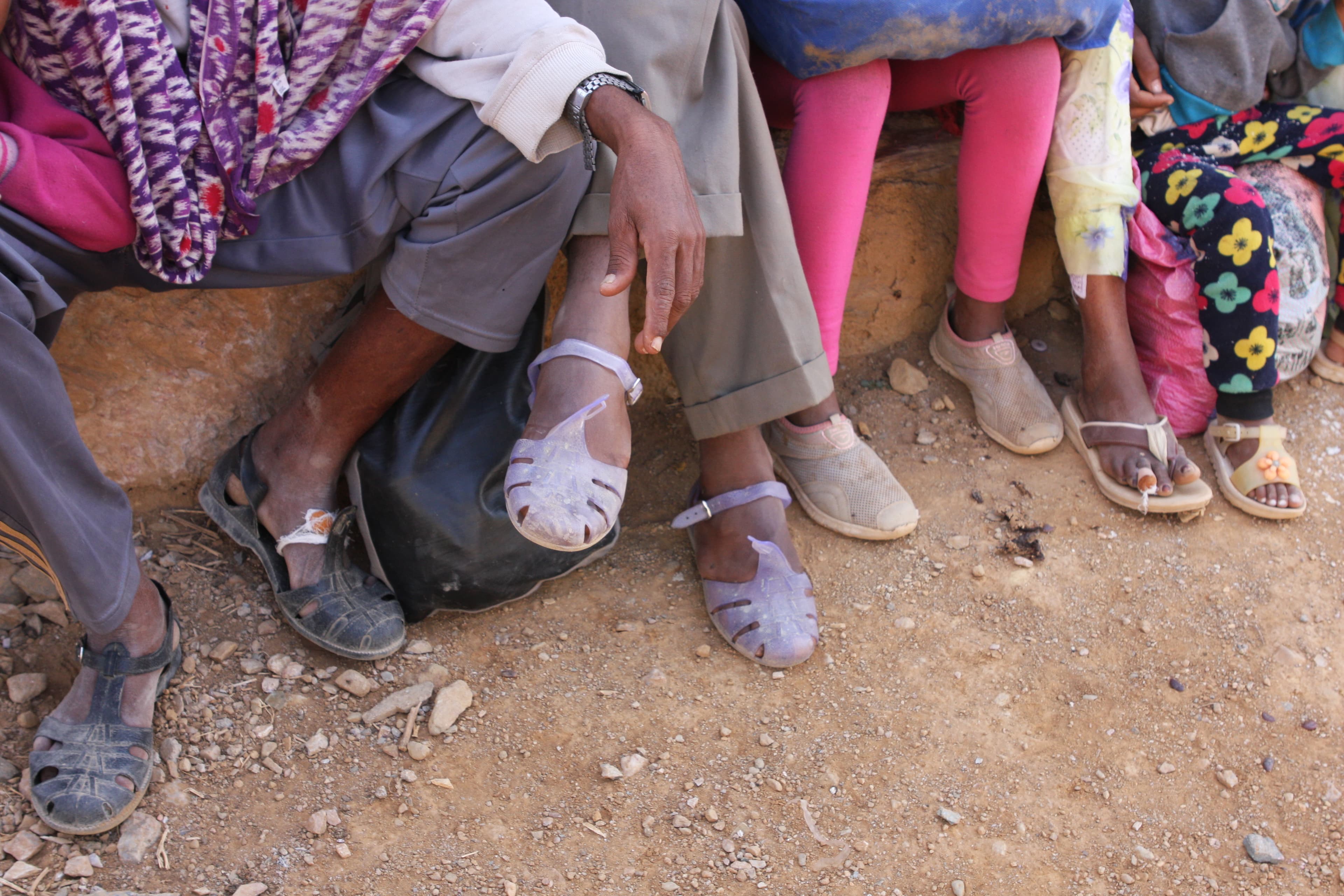 A group of Eritrean men, women and children who have just been dropped off in the small town of Adinbried, having crossed the border into Ethiopia the night before.