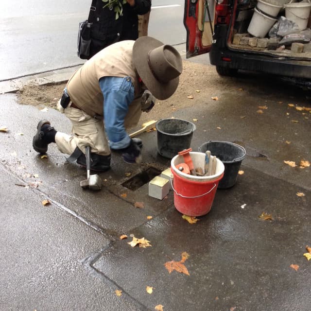 Artist Gunter Demnig at work laying stolpersteins in memory of Juliane and Simon Gaertner in Maintz, Germany October 15, 2015.