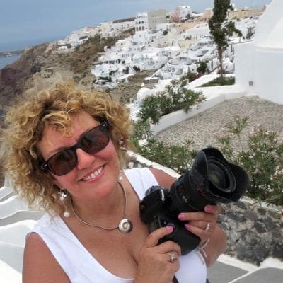 Woman holding a camera, smiling