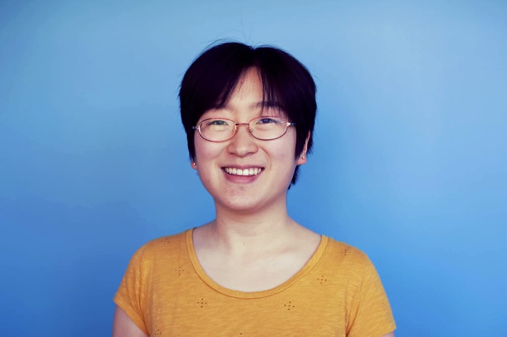 Portrait of woman against blue backdrop