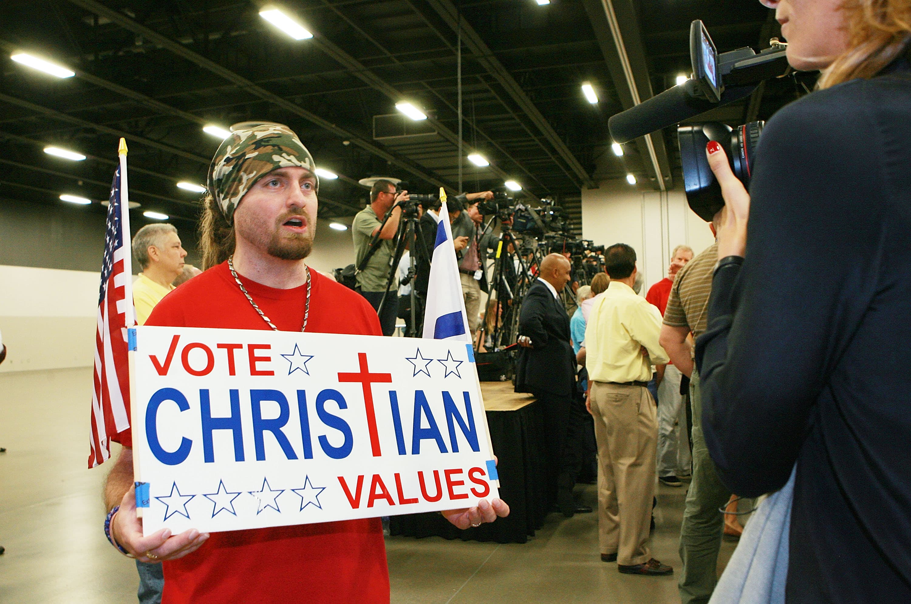 A man holds a sign for Republican presidential candidate Dr. Ben Carson