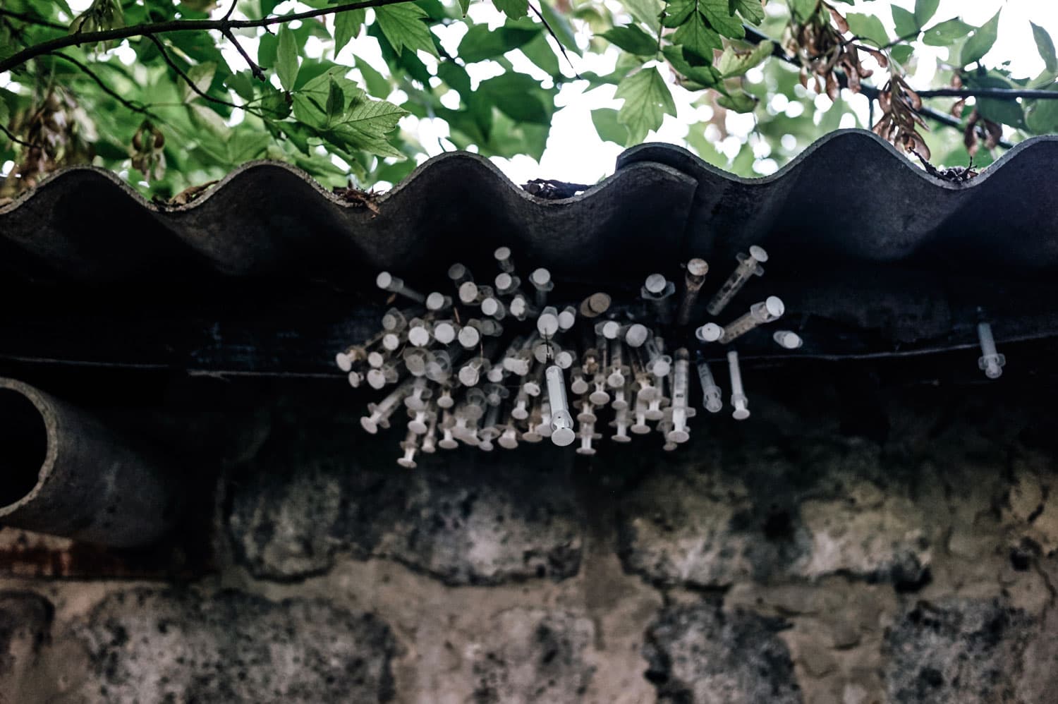 Discarded syringes stacked behind a garage in Borispol.