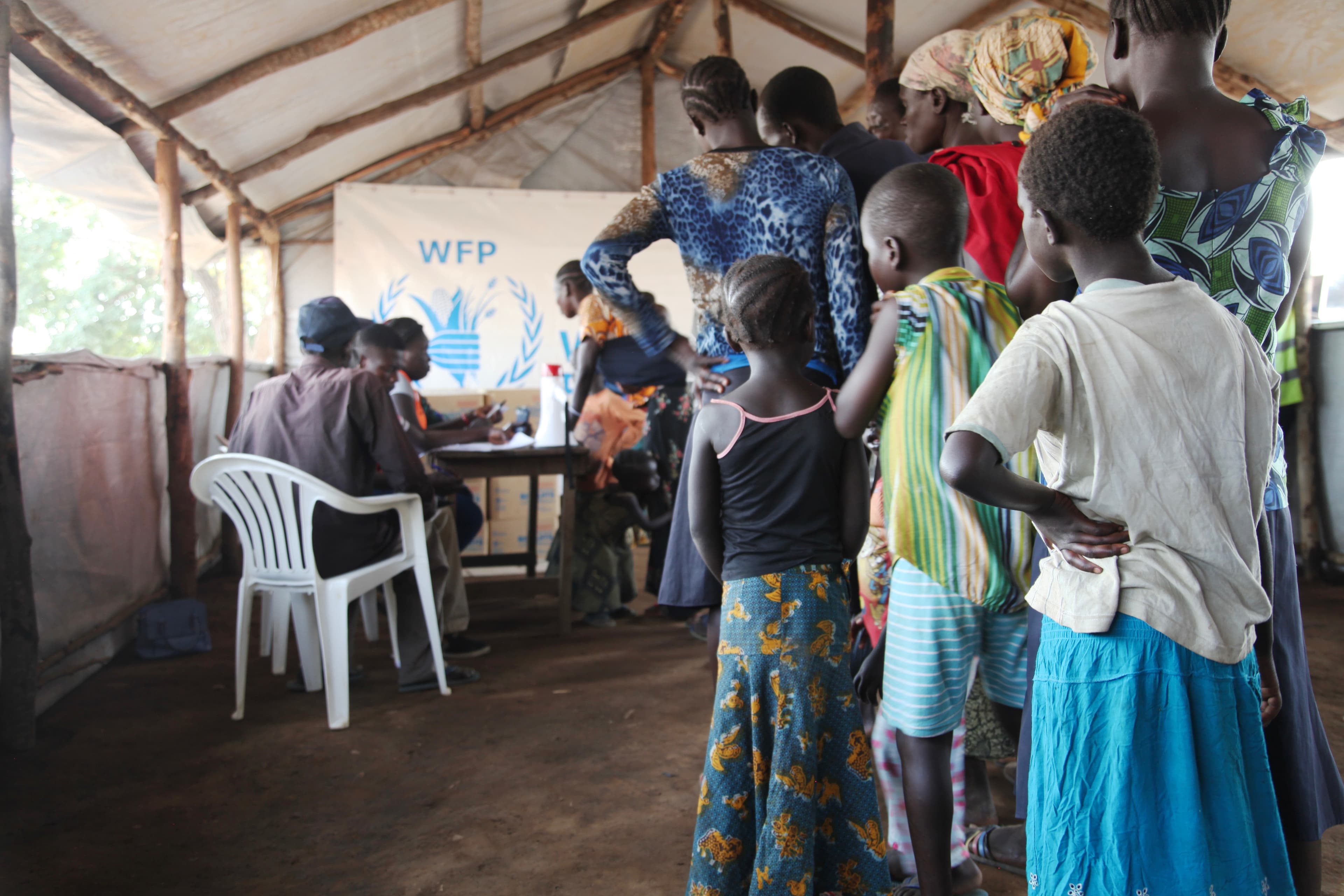 Refugees wait in line to be registered at a reception center near the border.