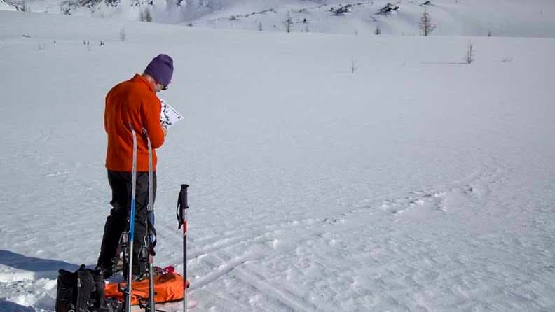 Simon Beck plots his course to begin his snow art project.