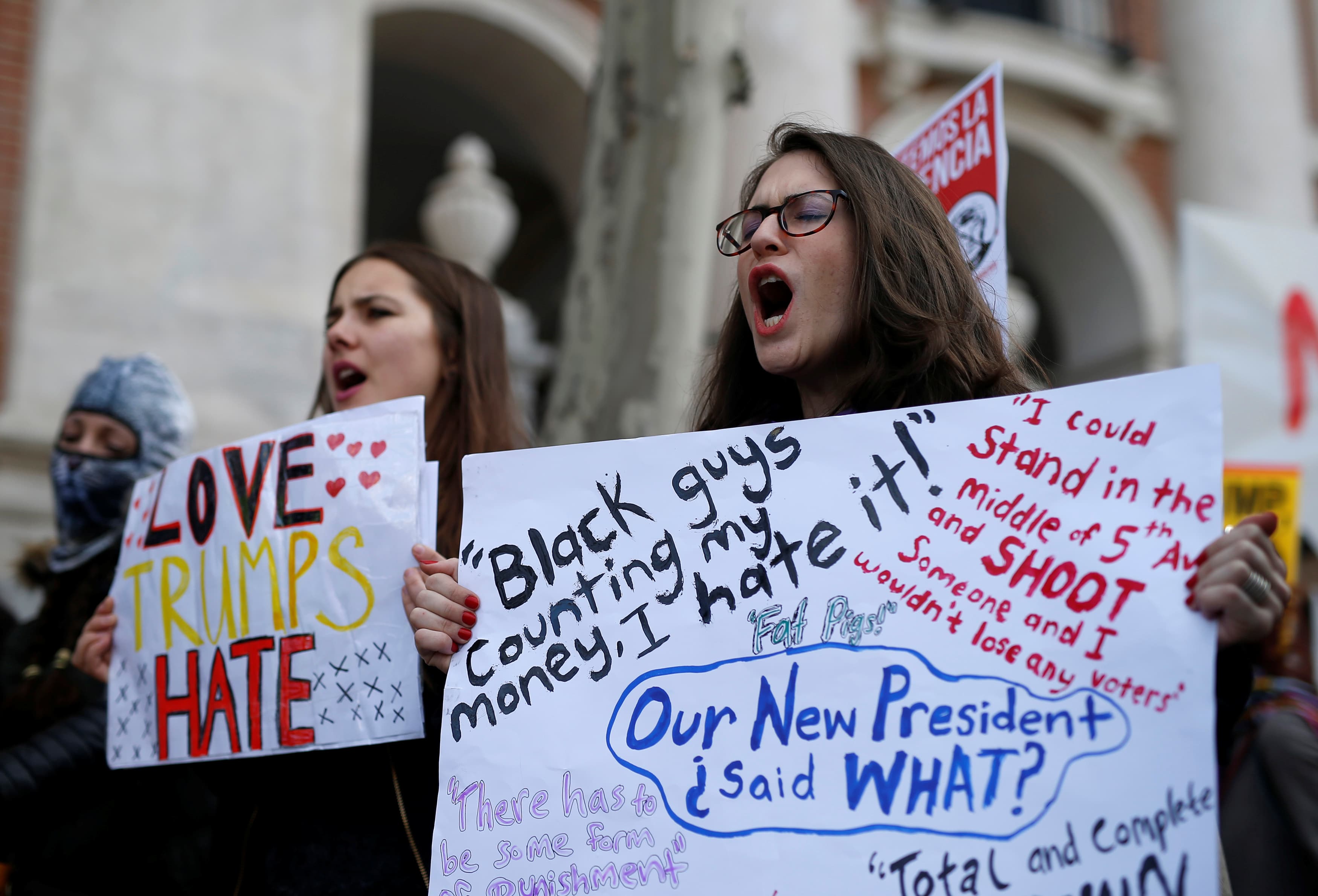 Women hold signs to show solidarity with the Women's March in Washington and many other marches in several countries, in Madrid, Spain