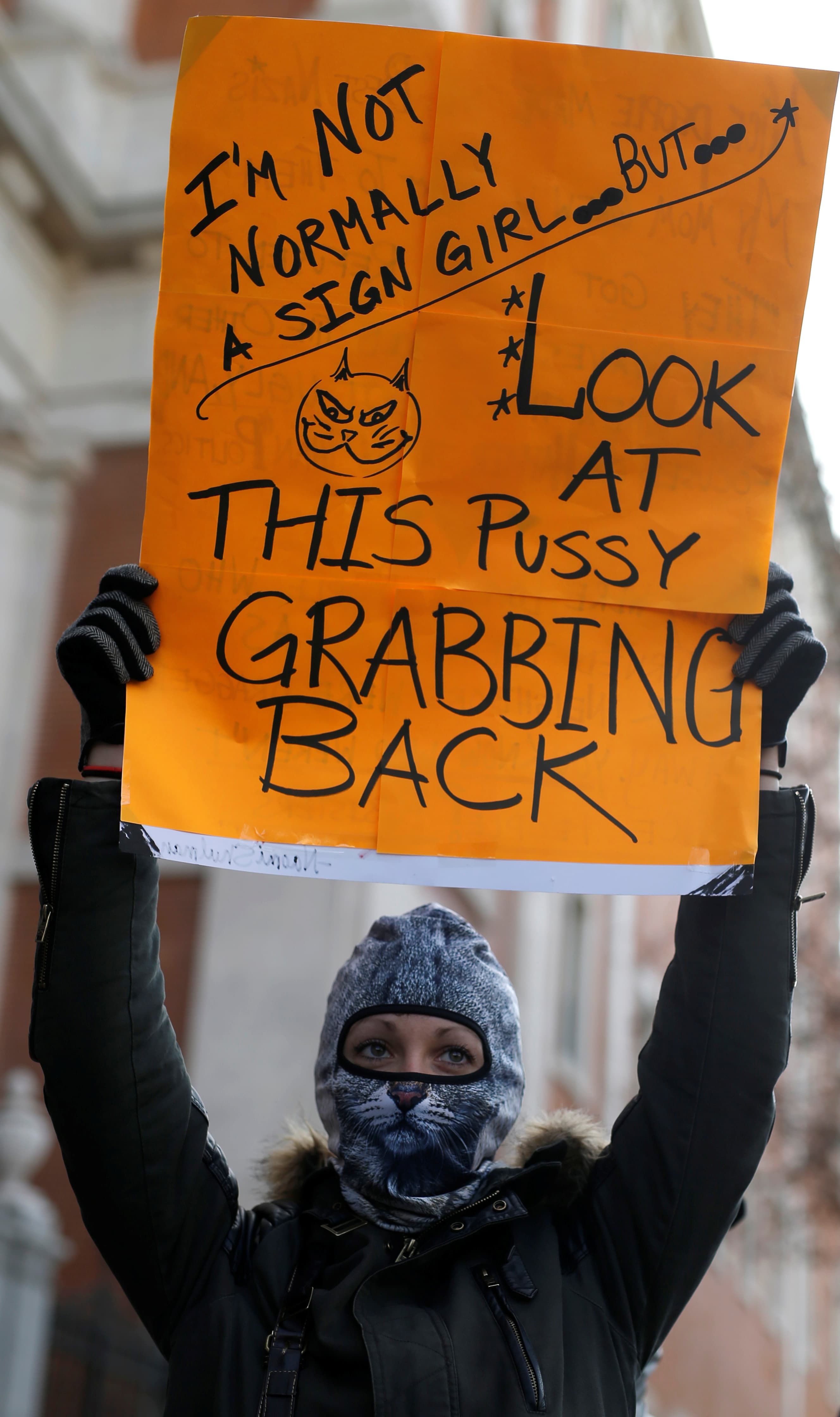 A woman holds a sign to show solidarity with the Women's March in Washington and many other marches in several countries, in Madrid, Spain