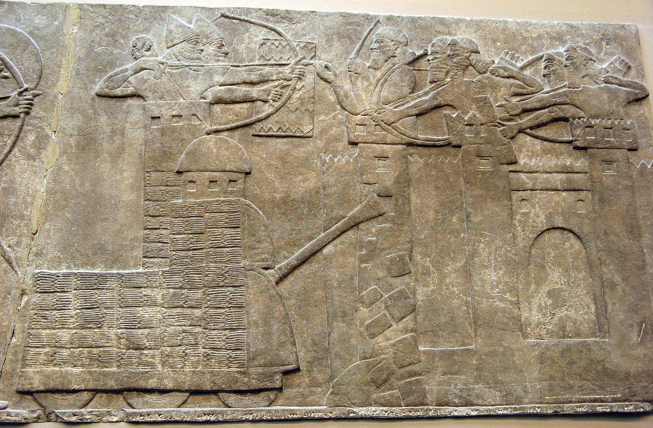 Assyrian attack on a town with archers and a wheeled battering ram; from a relief dated 865–860 BC, taken from the North-West Palace of Nimrud; now in the British Museum.