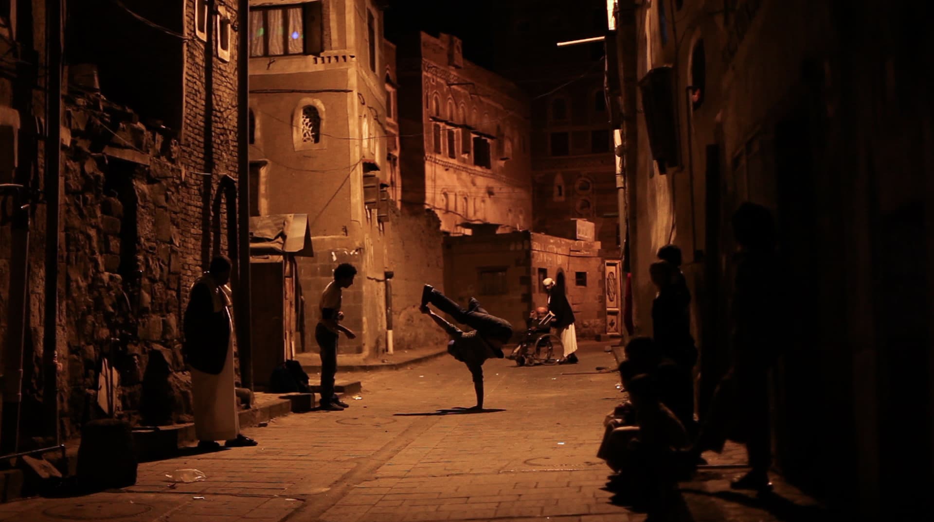 A break dancer strikes a pose in the streets of Sanaa, Yemen, in a scene from the new documentary, "Shake the Dust."
