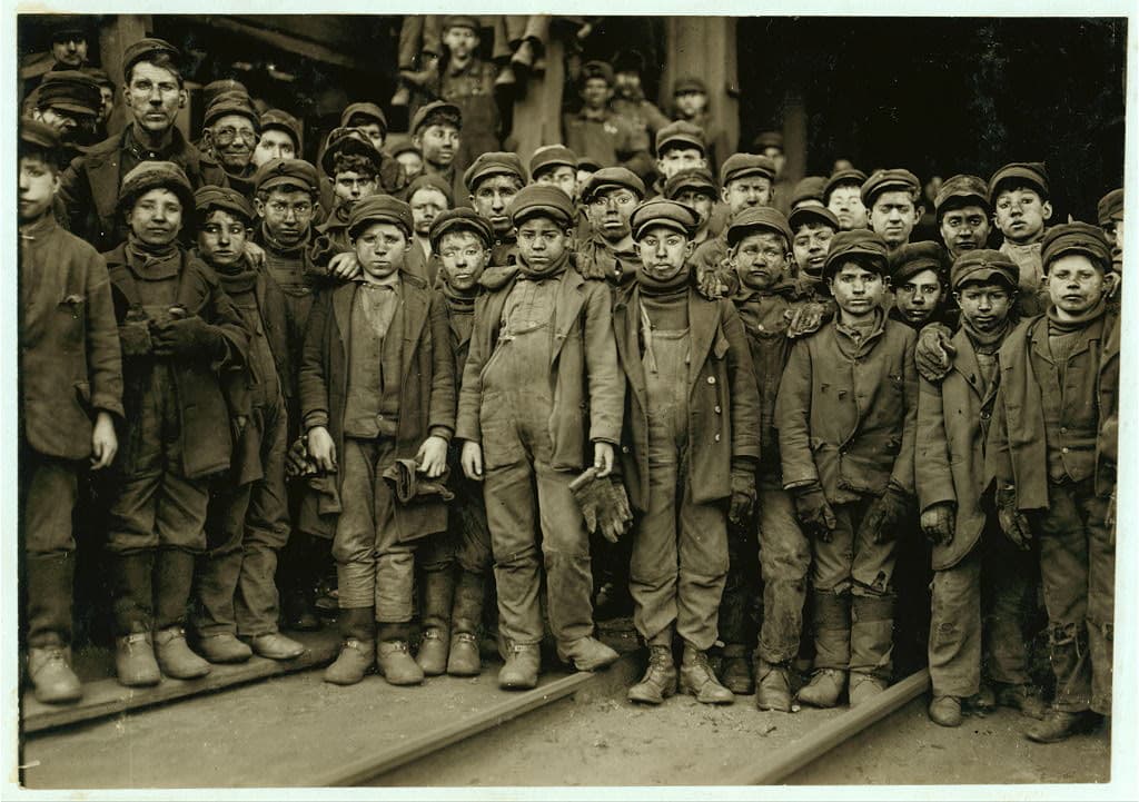 black and white photo of group of young boys, faces smudged
