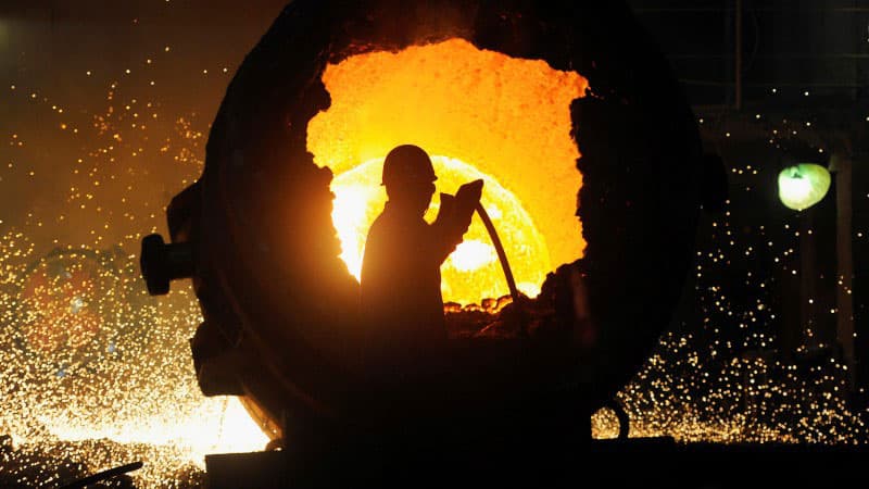 A man is silhouetted against a molten orange background.