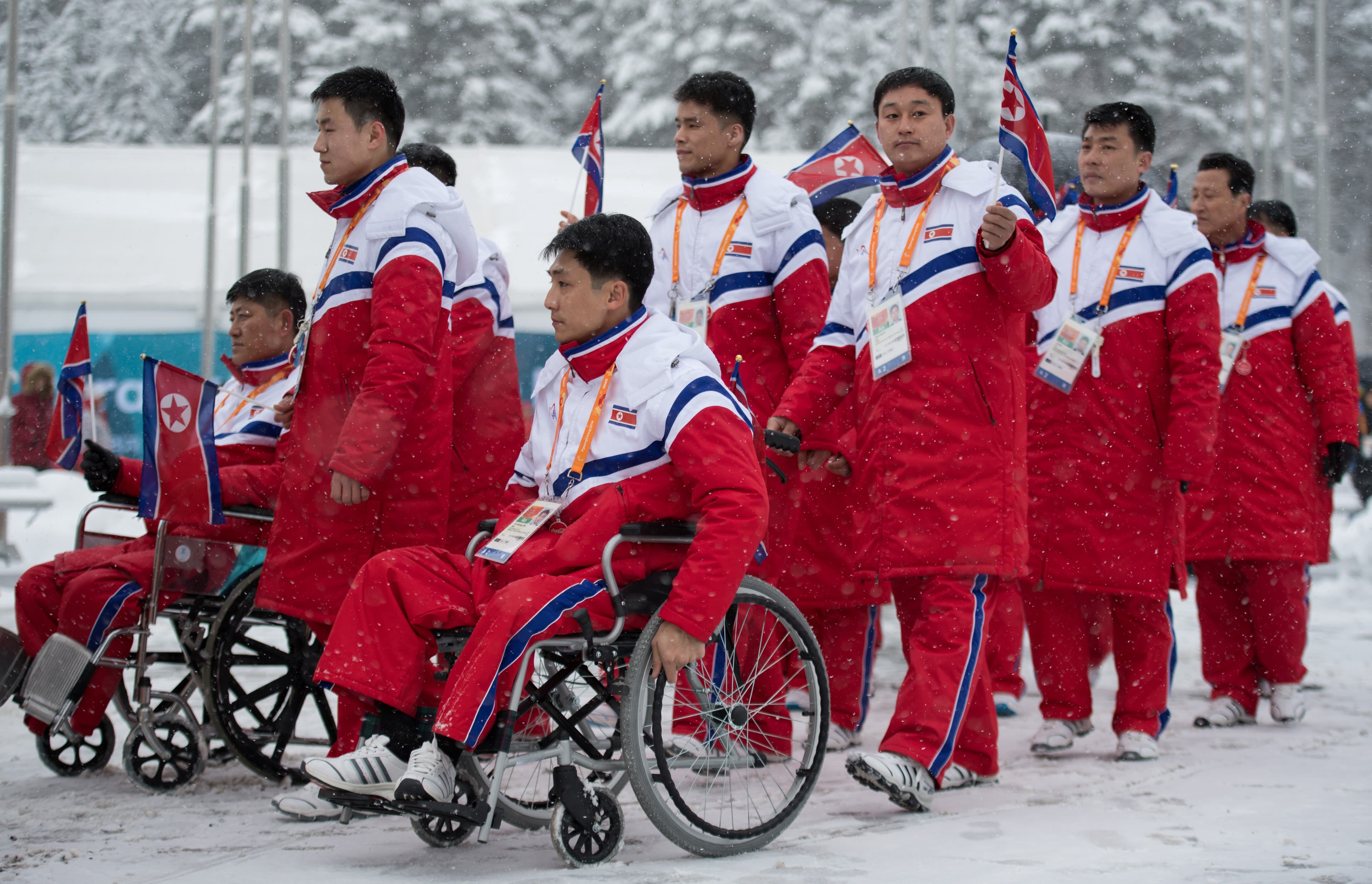 The delegation and the team of North Korea arrive at The Paralympic Village in Pyeongchang, South Korea, wearing red jumpsuits, March 8, 2018.
