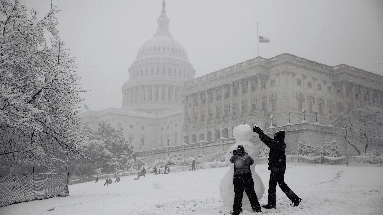 People build a snowman outside the US Capitol in Washington, D.C., March 21, 2018.