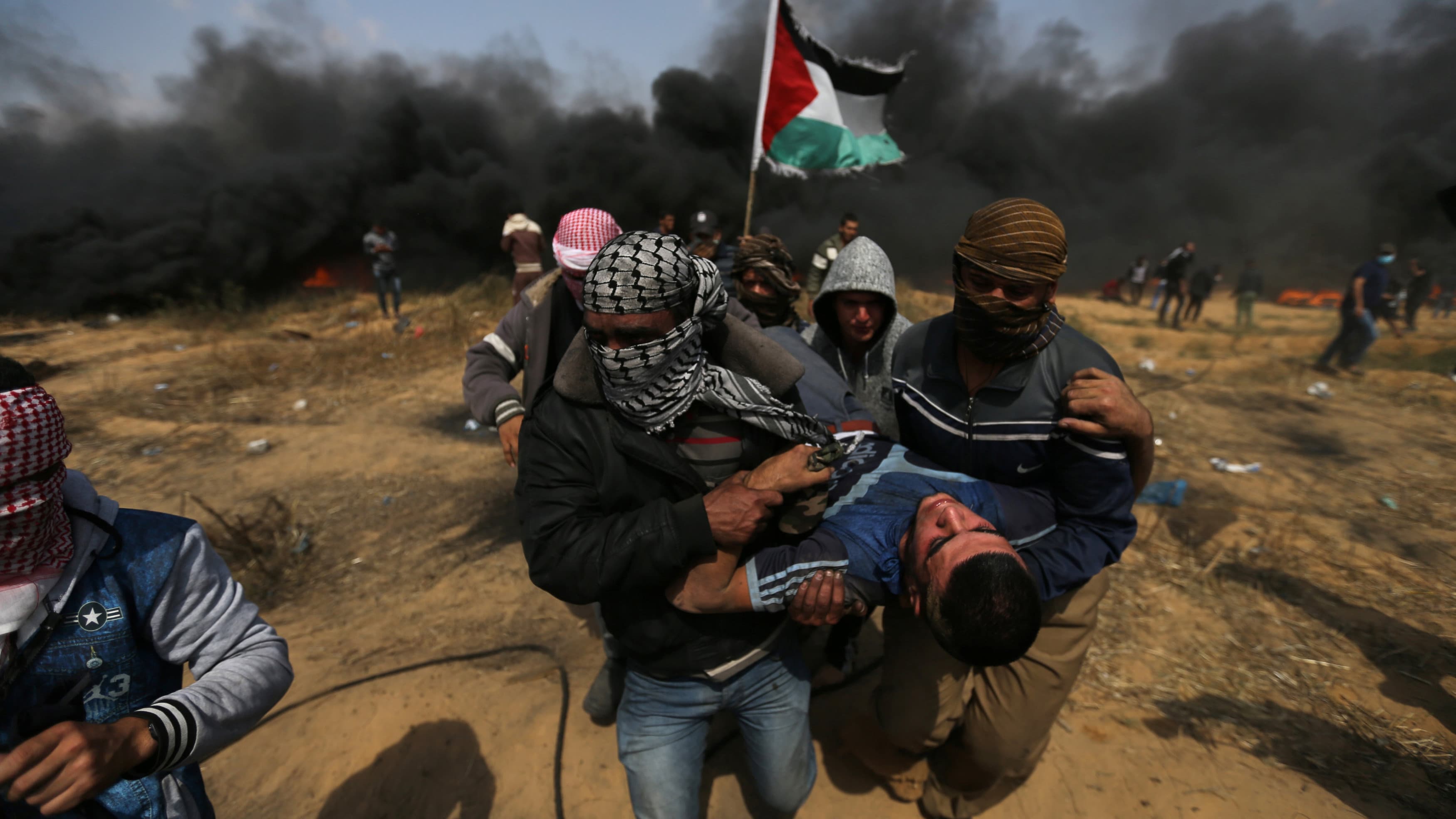 A wounded demonstrator is evacuated during clashes with Israeli troops at a protest where Palestinians demand the right to return to their homeland, at the Israel-Gaza border in the southern Gaza Strip, April 27, 2018.