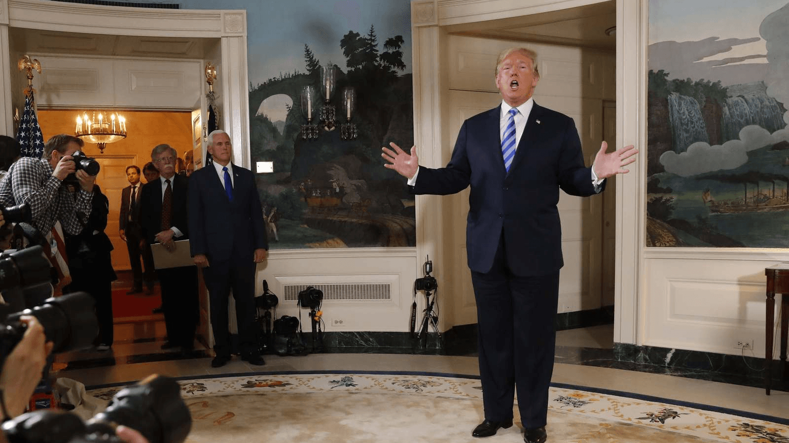 US President Donald Trump reacts to a question from the media as National Security Advisor John Bolton and Vice President Mike Pence look on after the president announced his intention to withdraw from the JCPOA Iran nuclear agreement.