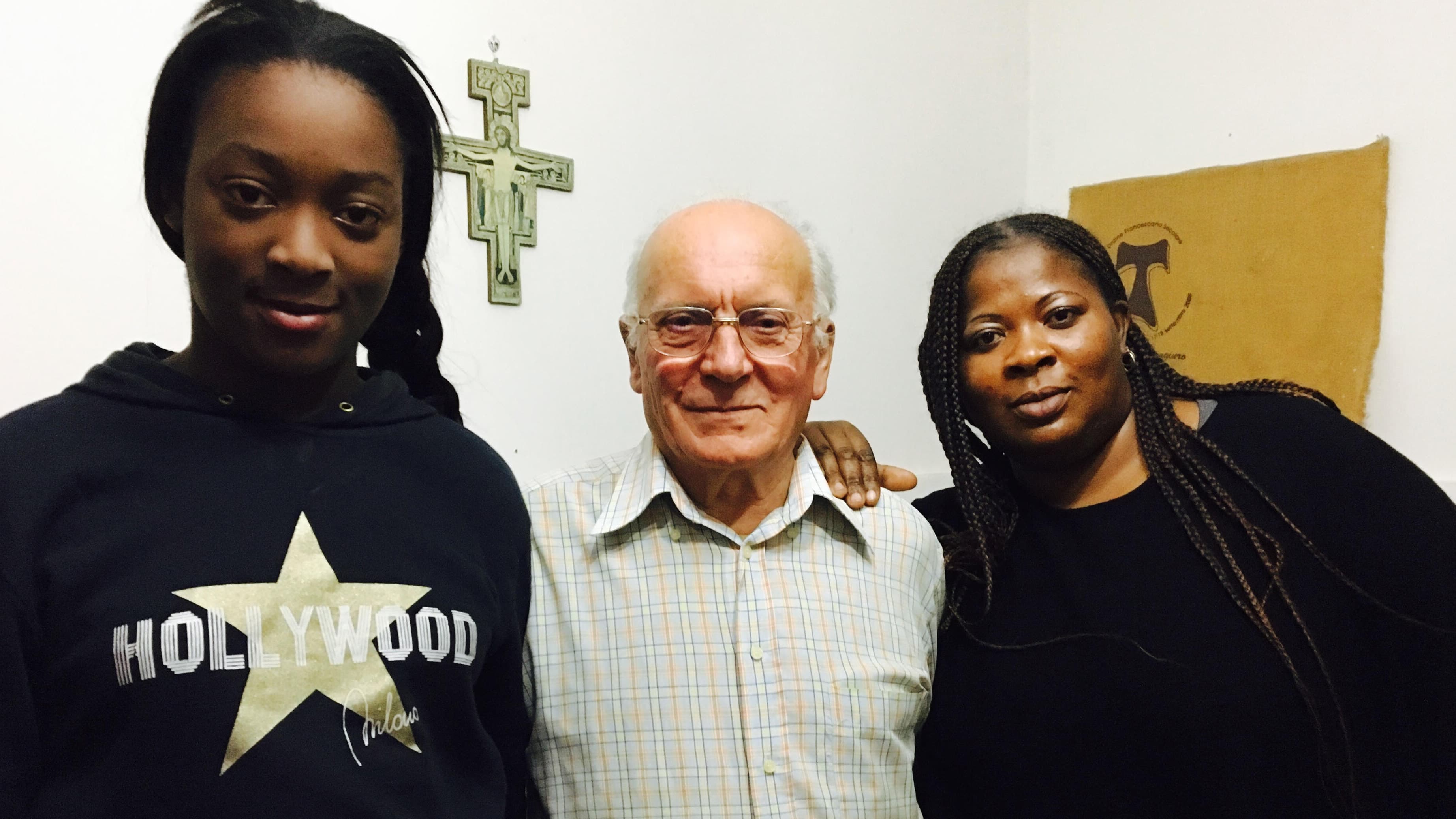 Three people pose for a photo together: a woman in her thirties on the right, her daughter, a teenager, on the left, and an older man in the middle